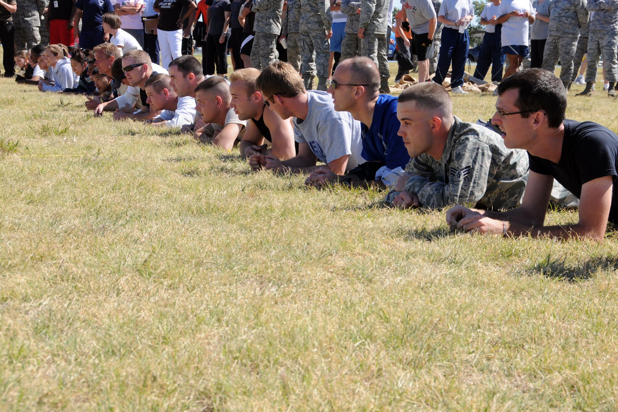 Guardsmen assigned to Will Rodgers Air National Guard base, prepare to low crawl during the base Olympics held at the base track, Oct. 1. The low crawl was one of the many events available to members that tested strength and endurance.
(U.S. Air Force Photo by Senior Airman Patricia Baker/Released)