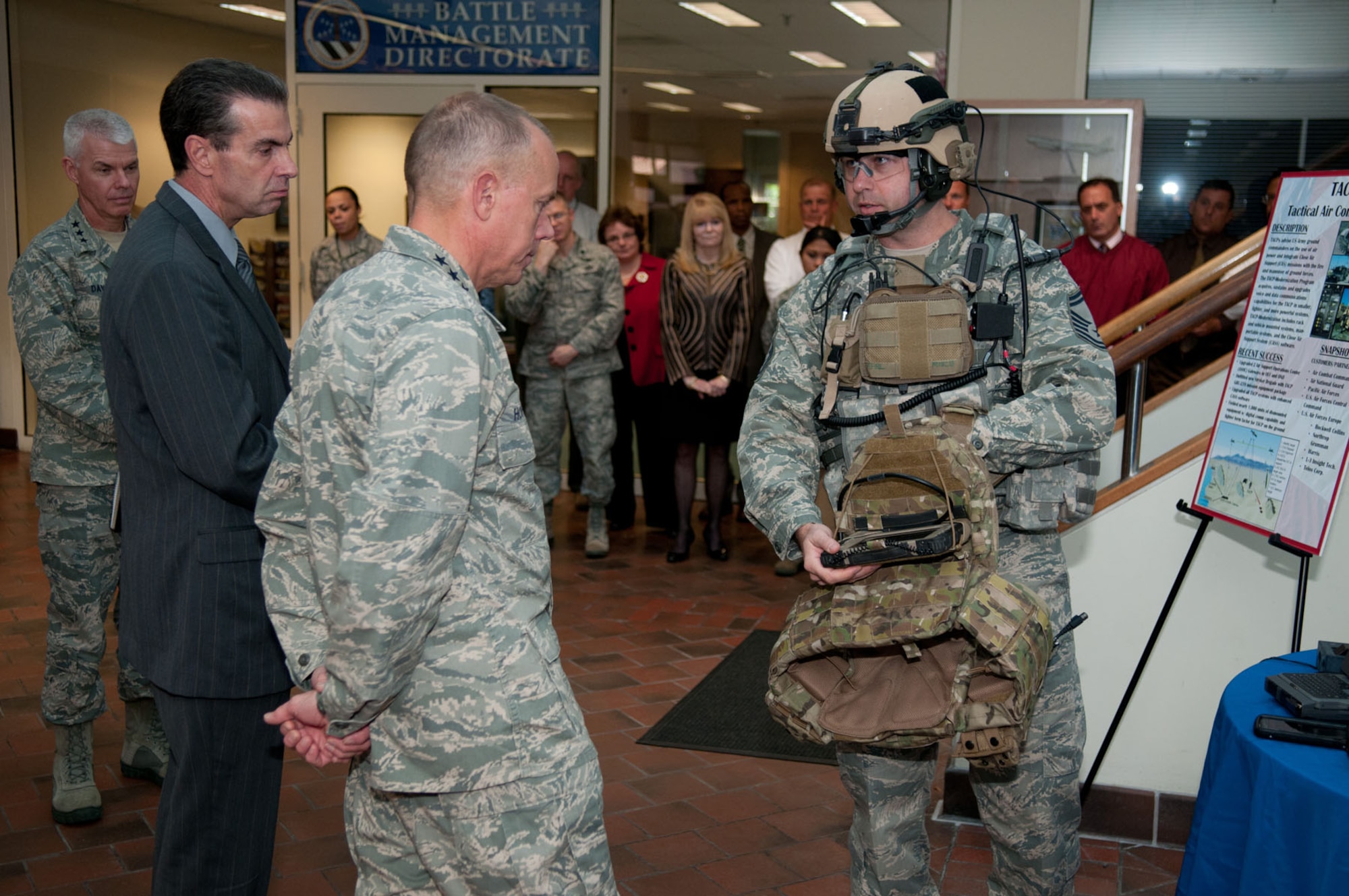 HANSCOM AIR FORCE BASE, Mass. – Gen. Donald Hoffman (middle), Air Force Materiel Command commander, learns about Tactical Air Control Party capabilities from Senior Master Sgt. Christopher Spann during a Battle Management Directorate overview in Building 1612 on Oct. 25. Lt. Gen. Charles R. Davis (left), Electronic Systems Center commander, and Ron Mason, Battle Management program executive officer, look on during the briefing. (U.S. Air Force photo by Rick Berry)