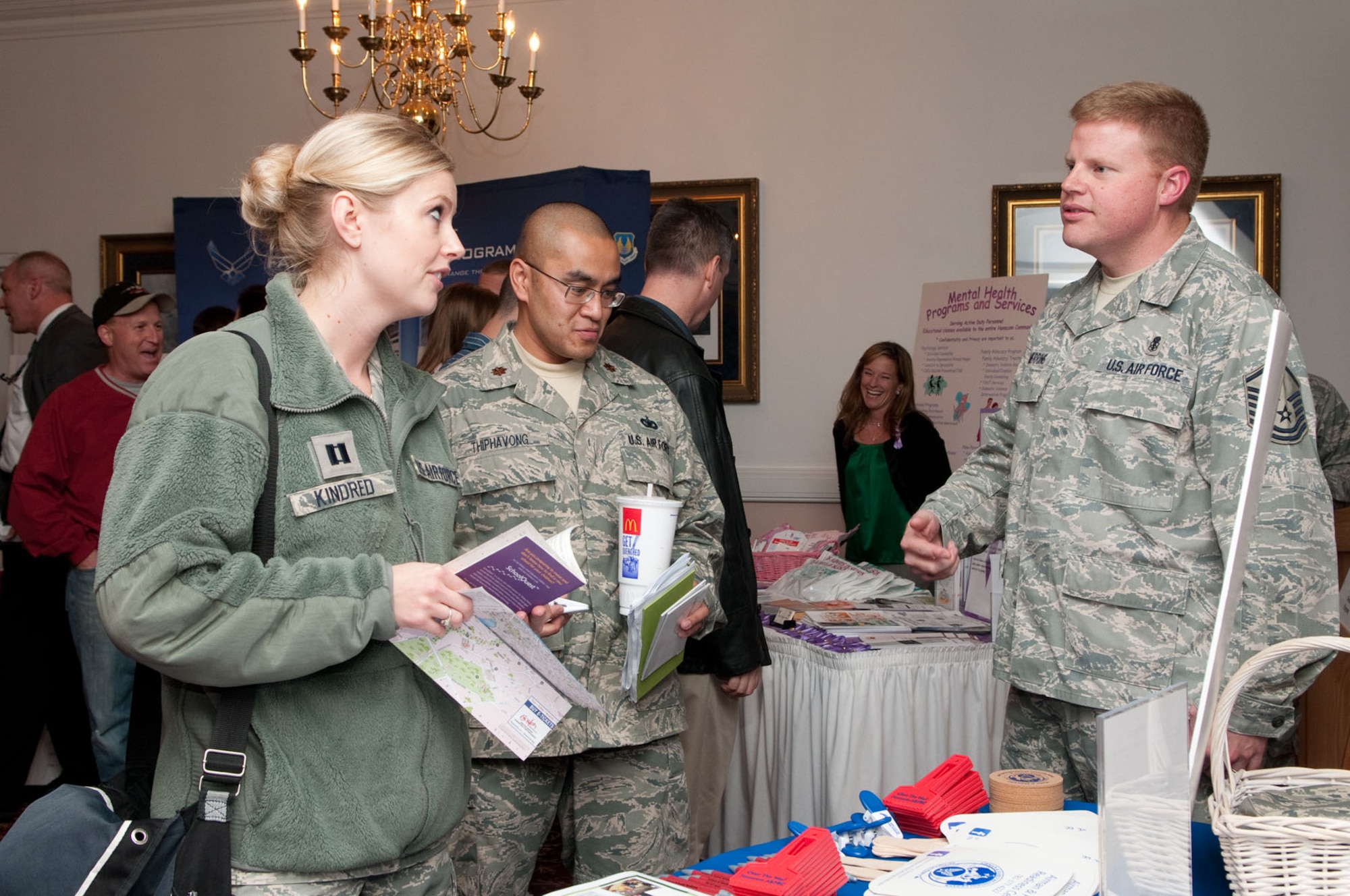 HANSCOM AIR FORCE BASE, Mass. – Master Sgt. Ray Merring (right), Airman and Family Readiness Center, gives out information about A&FRC programs and events to Capt. Jennifer Kindred and Maj. Sounthavone Thiphavong during the Base Residents Information Fair at the Minuteman Commons Oct. 19. (U.S. Air Force photo by Mark Herlihy)