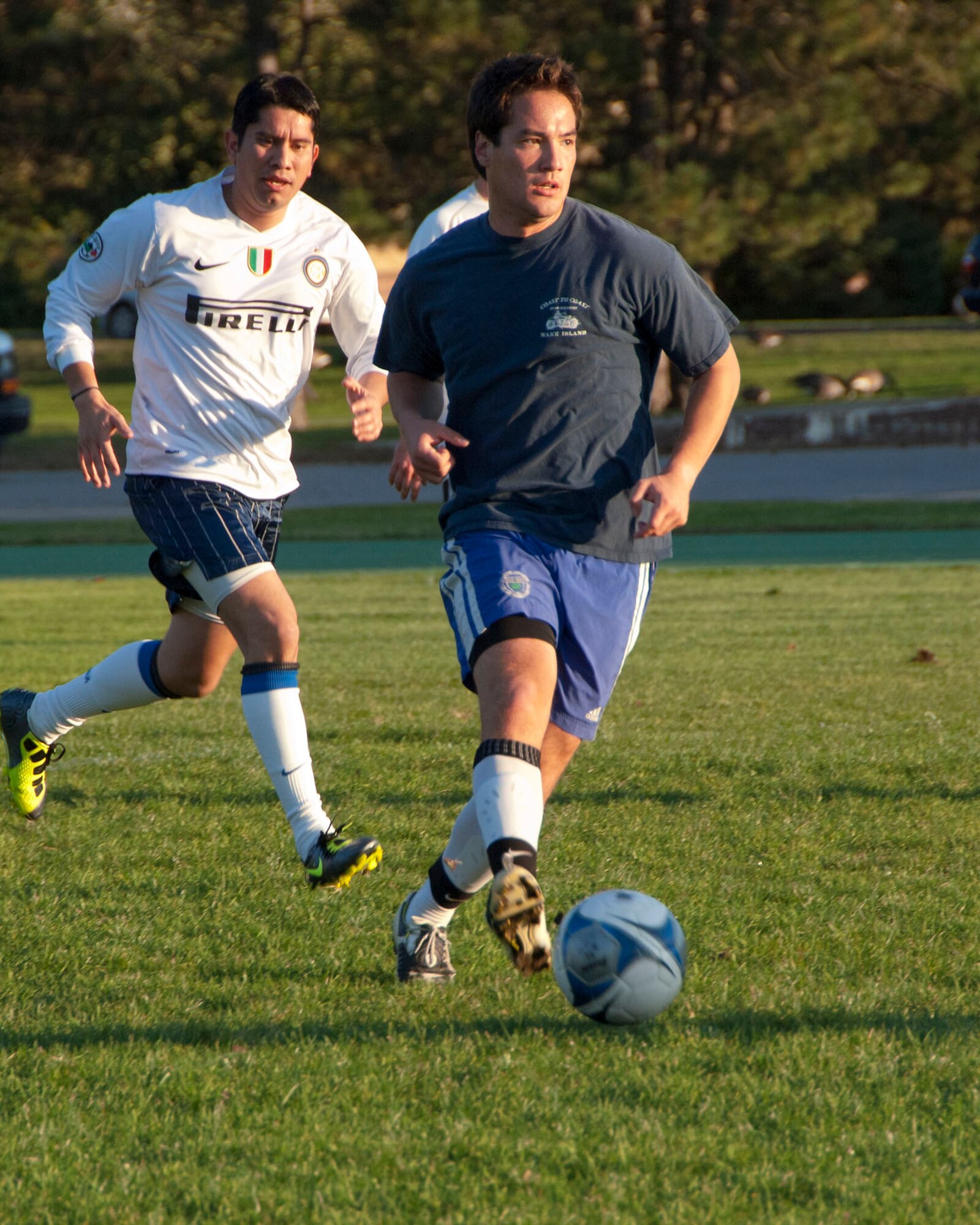HANSCOM AIR FORCE BASE, Mass. – Mike Long, playing for the 66th Comptroller Squadron team, kicks the ball with Florencio Mendoza chasing him during the intramural soccer championship game Oct. 17. 66 CPTS beat the HN/HB/HI team 2 to 1 to take home the trophy. (U.S. Air Force photo)