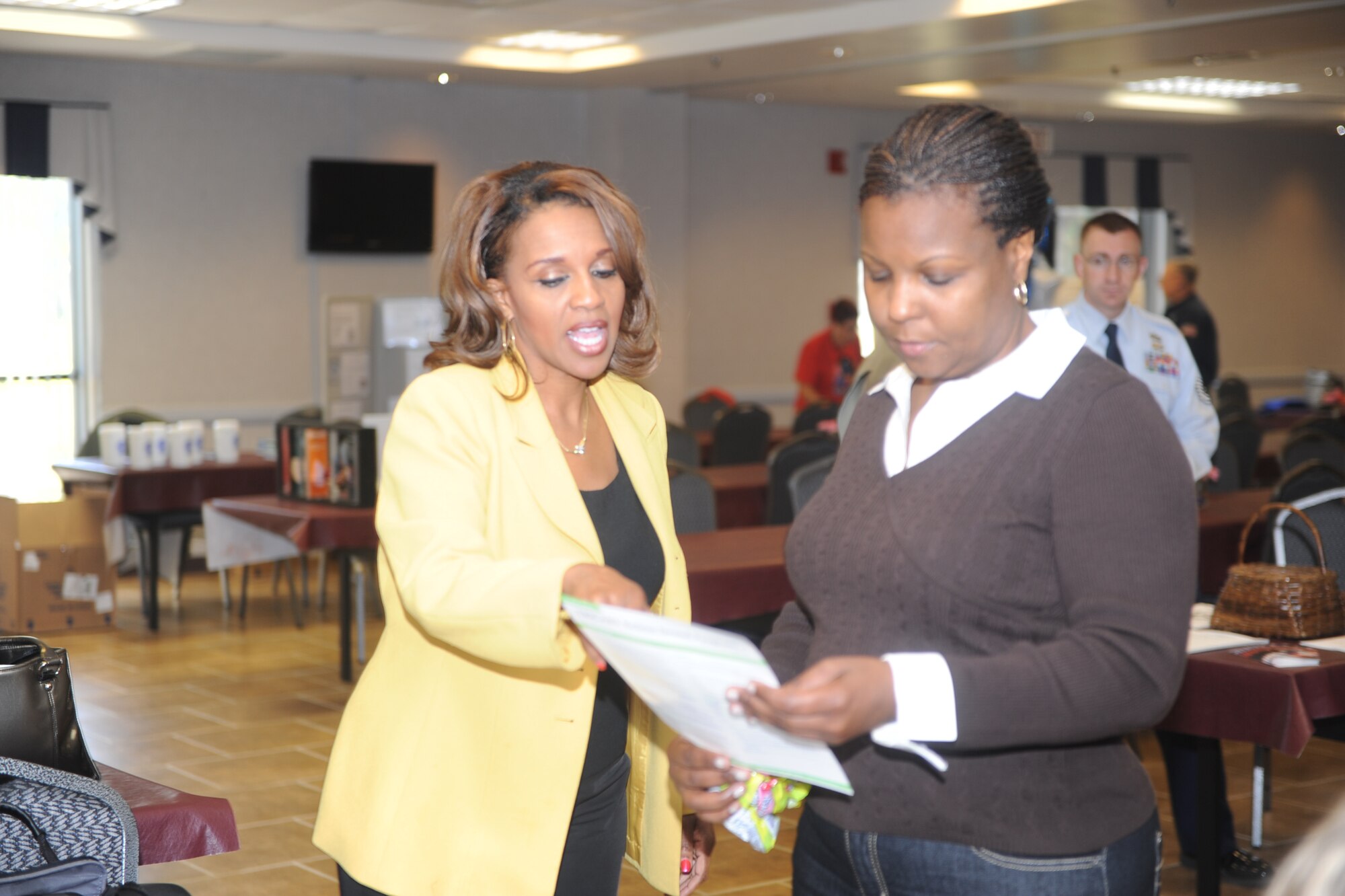 Michelle Banks-Gainer, a Federal Government Programs marketing representative, explains the Delta Dental program to a retiree. (U.S. Air Force photo by Raymond Crayton)
