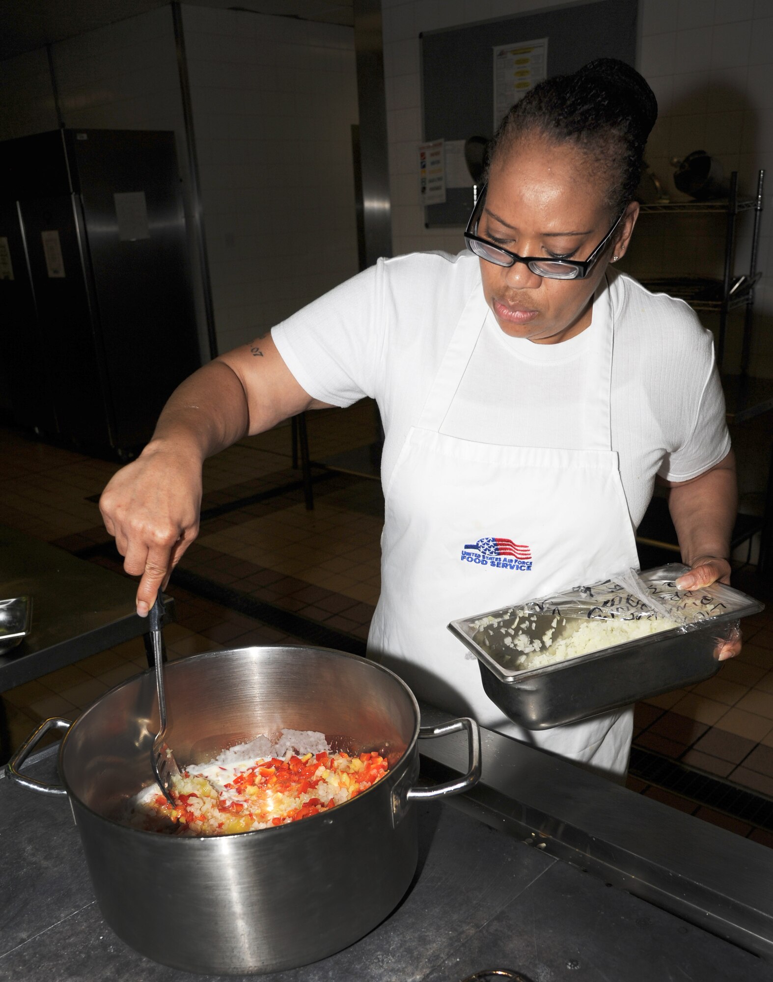 RAF MILDENHALL, England – Rose St. John, 100th Force Support Squadron Ministry of Defence head cook, mixes vegetables in preparation for dinner at the Gateway Dining Facility here Oct. 25, 2011. The vegetables are being cooked for a ginger rice dish that was served during dinner. (U.S. Air Force photo/Capt. Kristina Campana)