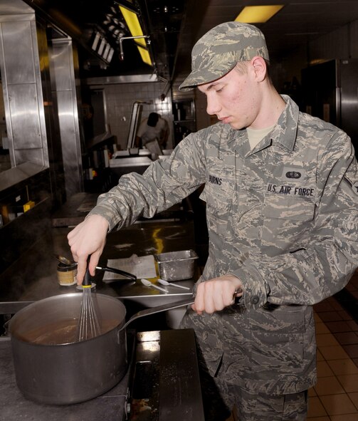 RAF MILDENHALL, England – Airman Thomas Burns, 100th Force Support Squadron food service apprentice, mixes a pot of gravy to be served with dinner at the Gateway Dining Facility here Oct. 25, 2011. There are nine 100th FSS Airmen along with Ministry of Defence and contractors who prepare and serve meals at the dining facility for 300 to 500 people on a daily basis. (U.S. Air Force photo/Capt. Kristina Campana)