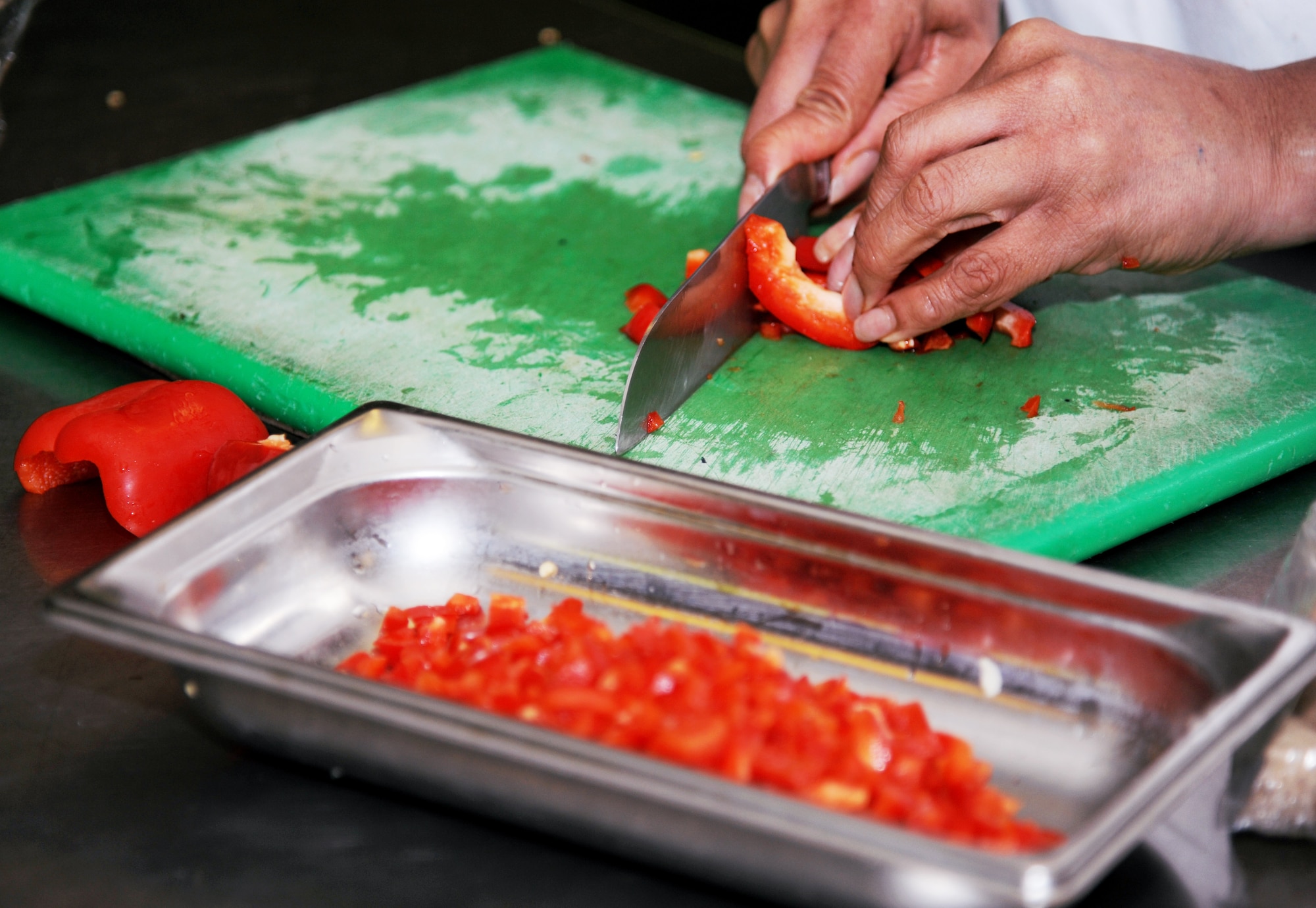 RAF MILDENHALL, England – A bell pepper is chopped in preparation for a dish that will be served during dinner at the Gateway Dining Facility here Oct. 25, 2011. The Gateway Dining Facility serves 300 to 500 people on a daily basis. (U.S. Air Force photo/Capt. Kristina Campana)