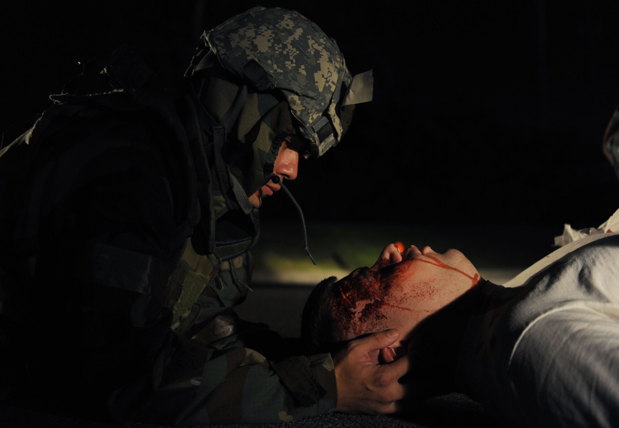 Capt. Jeffrey Drake, 18th Aeromedical Evacuation Squadron operations support flight commander, makes sure to steady the neck and head of a simulated car accident victim as part of a self-aid and buddy care scenario during local operational readiness exercise Beverly High 12-1 at Kadena Air Base, Japan, Oct. 26.Kadena uses moulage victims to give LORE scenarios added realism and creates a more urgent feeling in responders when they see the "wounds." (U.S. Air Force photo/ Senior Airman Sara Csurilla/ released)