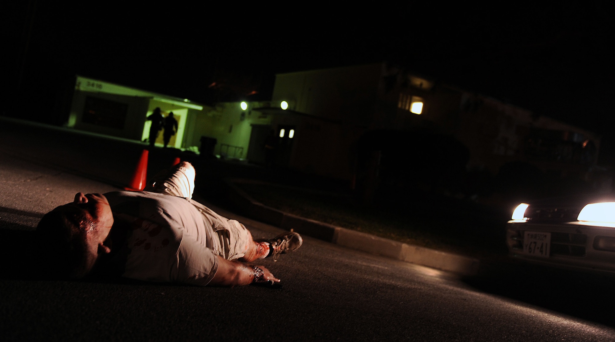 U.S. Air Force Airman 1st Class Beau Shelley, 18th Equipment Maintenance Squadron armament apprentice, plays the victim of a car accident waiting to be tended to by Airmen participating in local operational readiness exercise Beverly High 12-1 at Kadena Air Base, Japan, Oct. 26. The use of victims like Shelley creates a heightened sense of urgency in responders when they see the "wounds" they are responsible for caring for. (U.S. Air Force photo/ Senior Airman Sara Csurilla/ released)