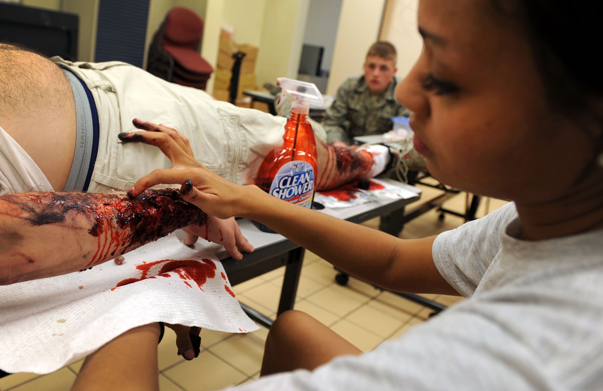 U.S. Air Force Staff Sgt. Britney Jones, 18th Dental Squadron dental journeyman, adds finishing touches to a fake arm wound on a moulage victim during local operational readiness exercise Beverly High 12-1 at Kadena Air Base, Japan, Oct. 26. Jones prepares the simulated victims for specific exercise scenarios needed during the LORE for use in more realistic training for Kadena?s Airmen. (U.S. Air Force photo/ Senior Airman Sara Csurilla/ released)