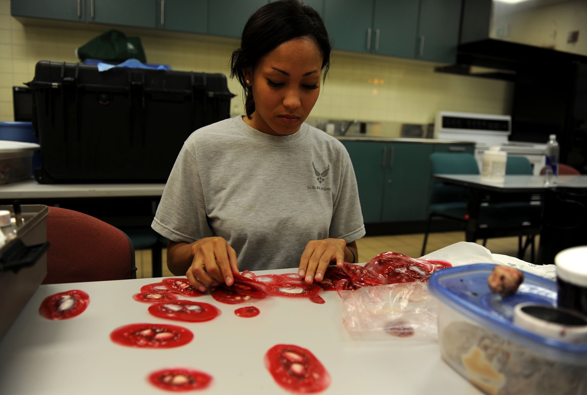 U.S. Air Force Staff Sgt. Britney Jones, 18th Dental Squadron dental journeyman, looks over fake wounds needed to apply the moulage to simulated victims during local operational readiness exercise Beverly High 12-1 at Kadena Air Base, Japan, Oct. 26. It's the job of Jones and other volunteers applying moulage that helps add realism and urgency to exercise scenarios. (U.S. Air Force photo/ Senior Airman Sara Csurilla/ released)