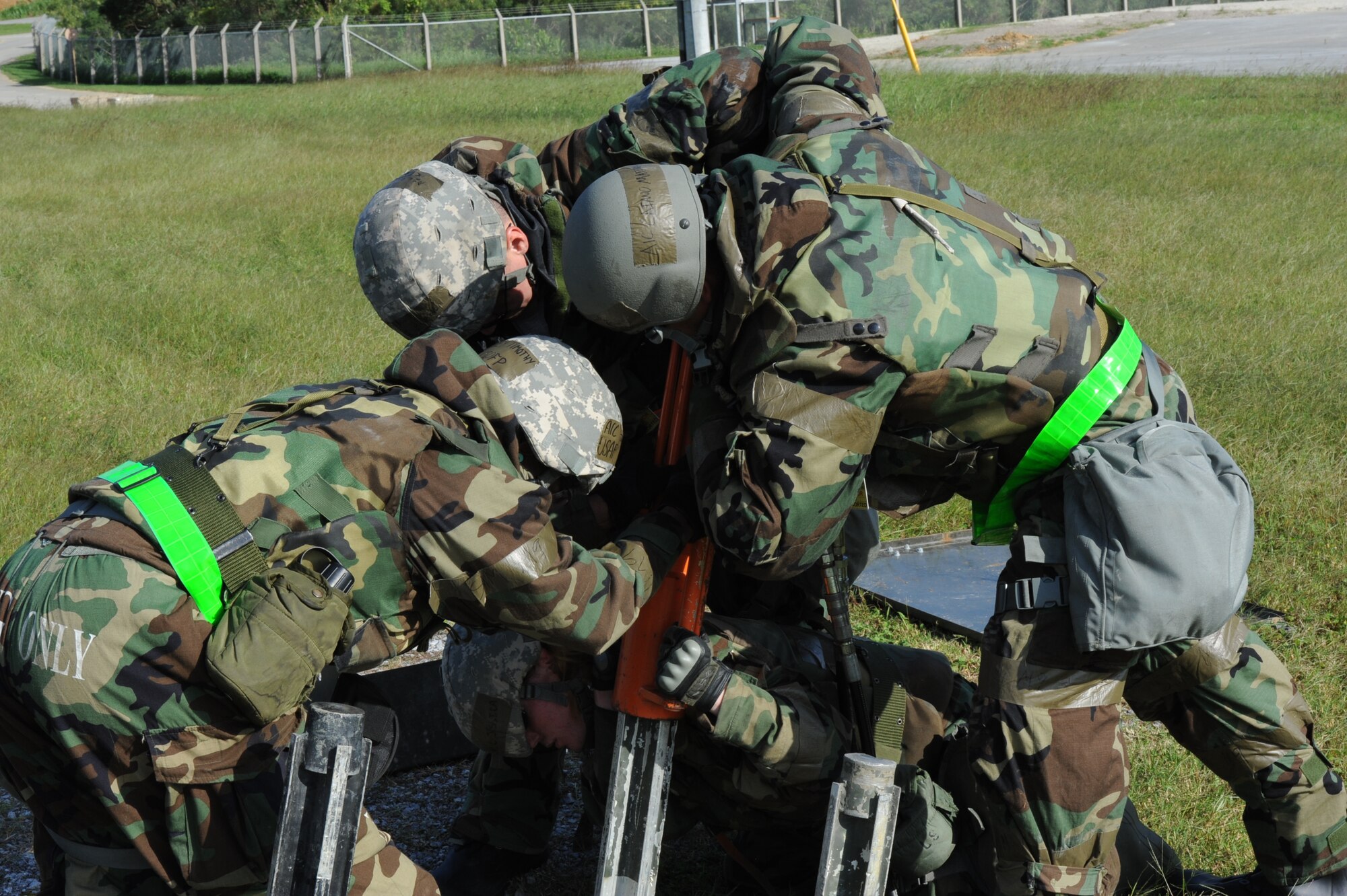 U.S Air Force Airmen from the 18th Civil Engineer Squadron help each other push an anchor into the ground during local operational readiness exercise Beverly High 12-1 on Kadena Air Base, Japan, Oct. 27. Beverly High 12-1 gives service members a chance to test their combat readiness as well as timeliness.  (U.S. Air Force Photo/ Airman 1st Class Justin Veazie/Released)