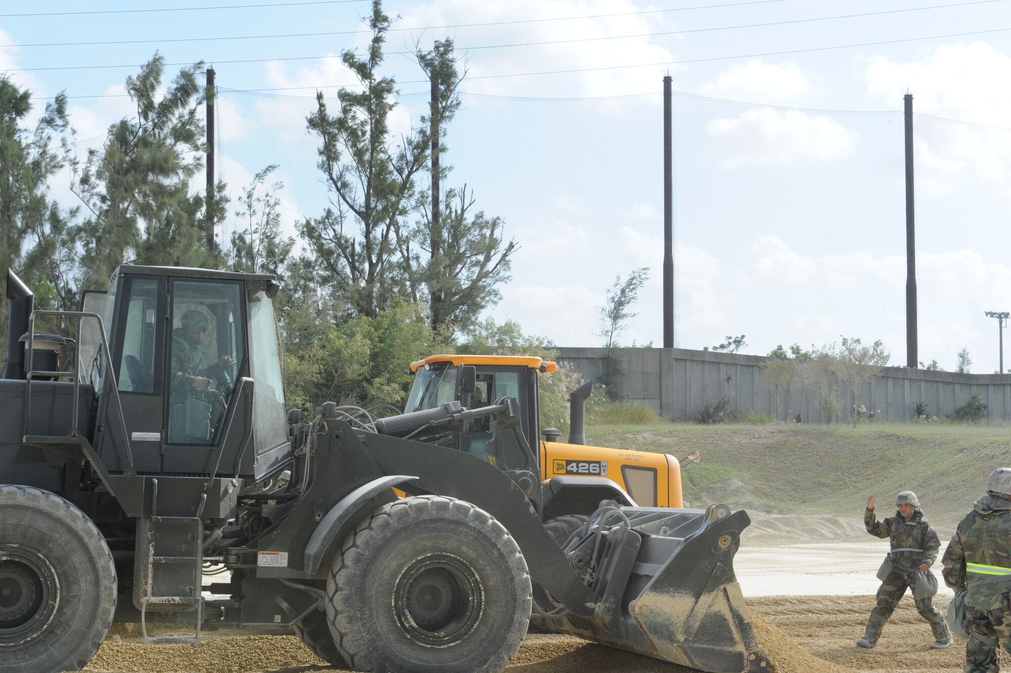 U.S. Air Force Airman 1st Class Loren Casias, 18th Civil Engineer Squadron, directs oncoming traffic during exercise Beverly High 12-1 on Kadena Air Base, Japan, Oct. 25. The exercise gives service members a chance to test their combat readiness as well as timeliness. (U.S. Air Force Photo/Airman 1st Class Justin Veazie/Released)