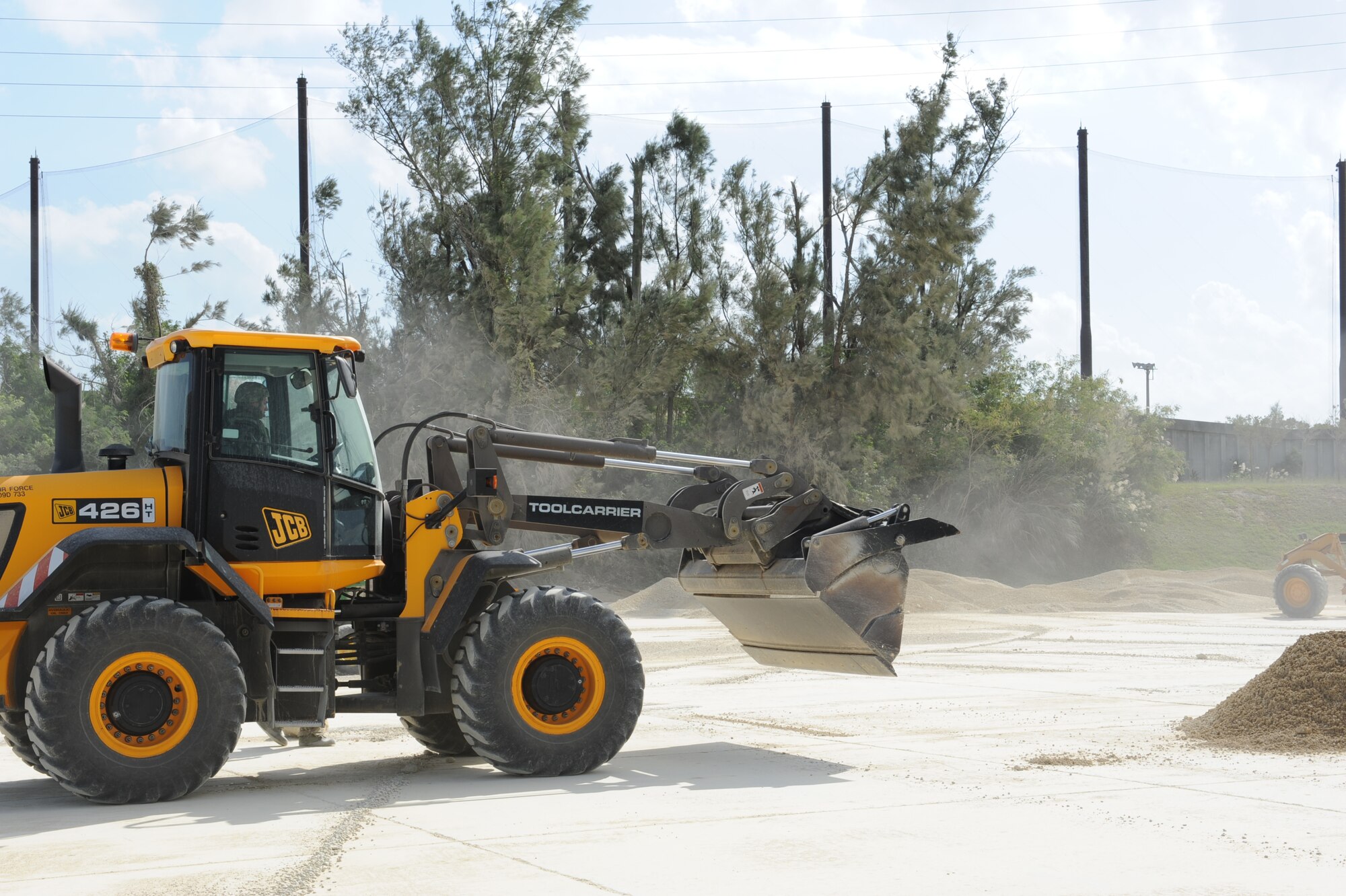 U.S. Air Force Airman 1st Class Dustin Brooks, 18th Civil Engineer Squadron structures technician, moves dirt during a flight line repair drill at Kadena Air Base, Japan, Oct. 25.Exercise Beverly High 12-1 provides service members an opportunity to test their combat readiness. (U.S. Air Force Photo/Airman 1st Class Justin Veazie/Released)