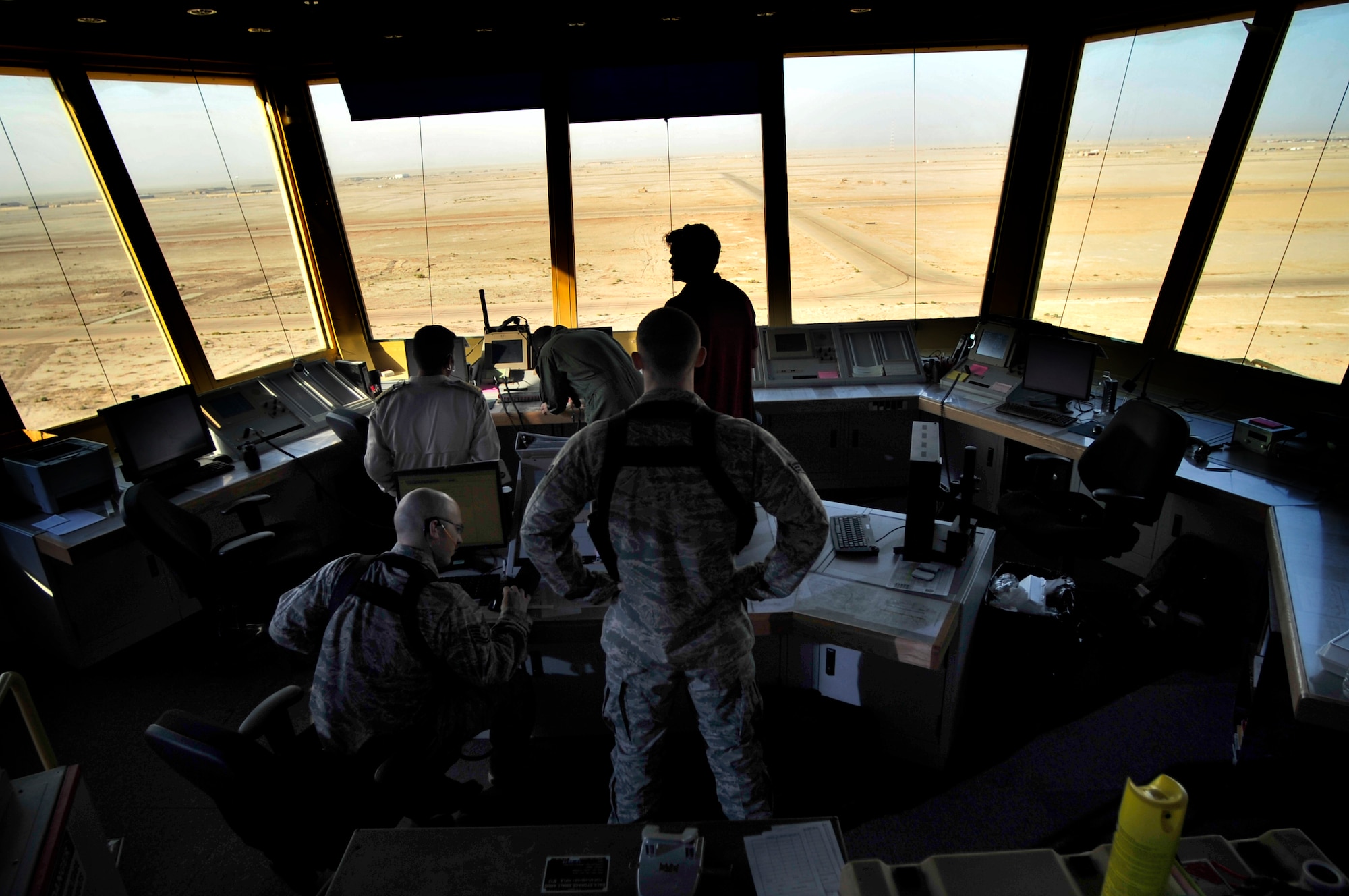Tech. Sgt. Bryce Hamilton and Senior Airman Matt Morrow, 407th Air Expeditionary Group air traffic controllers, and a U.S. contractor, aid in training Iraqi counterparts to take control of the air space in Iraq.  With the Air Force’s assistance, Iraq now has full air traffic control responsibility for the country’s airspace for the first time since 2003. The Air Force transferred management of the Baghdad and Balad Airspace sector to the Iraq Civil Aviation Authority (ICAA) on Oct. 1, 2011. With this historic step, Iraq’s air traffic controllers now direct the movement of all aircraft within the busiest and most complex airspace in Iraq. (U.S. Air Force photo/Master Sgt. Cecilio Ricardo)