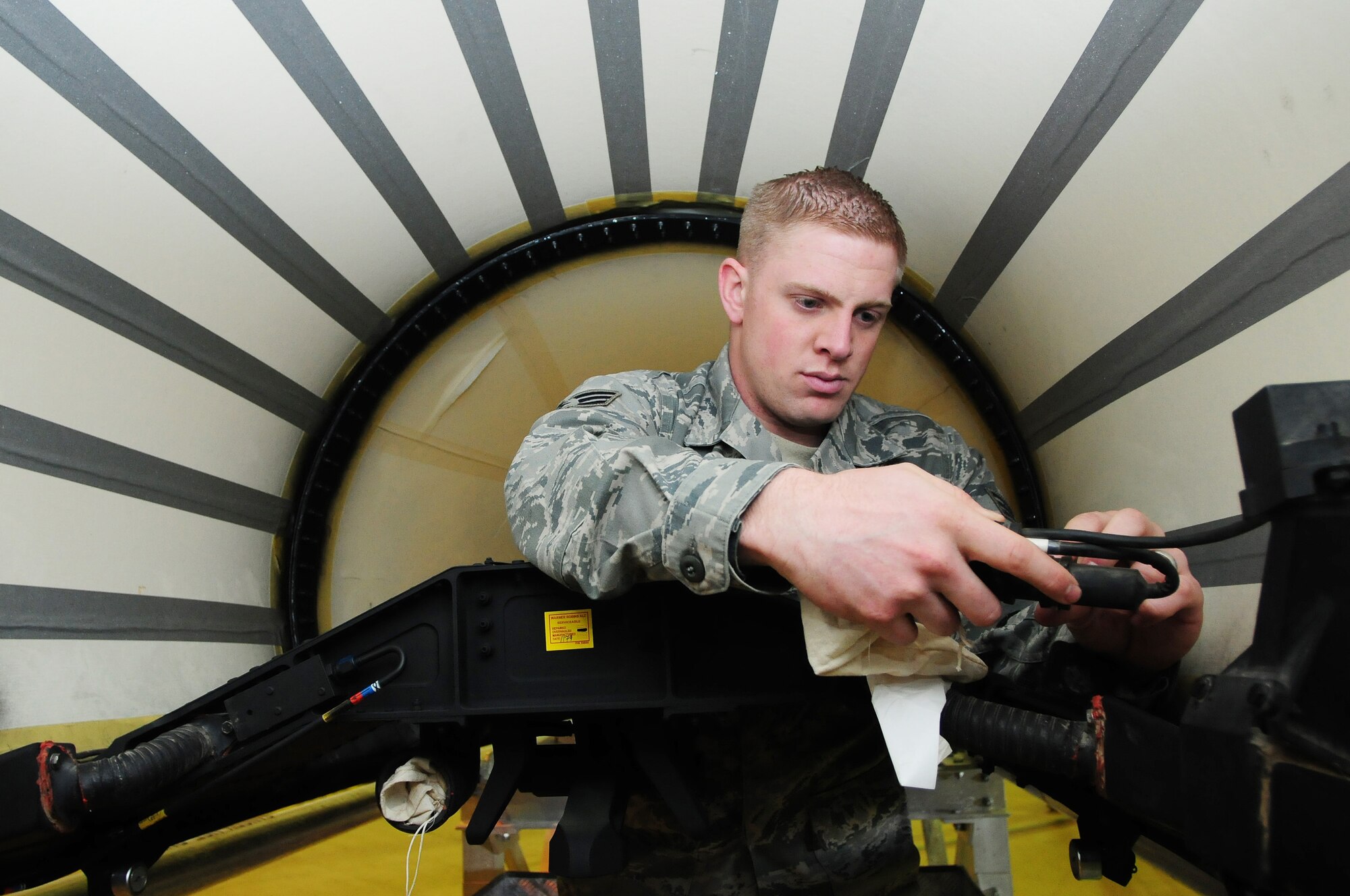 ROYAL AIR FORCE LAKENHEATH, England - Senior Airman Matthew Bieniek, 48th Equipment Maintenance Squadron repair and reclamation journeyman, inspects the interior of a brand new aircraft canopy prior to performing a rig check, Oct. 26, 2011. A rig check ensures a proper fit before a canopy is installed on a jet. Bieniek was nominated for a Liberty Spotlight because he displays the core value of "excellence in all we do." (U.S. Air Force photo by Senior Airman Lausanne Morgan)