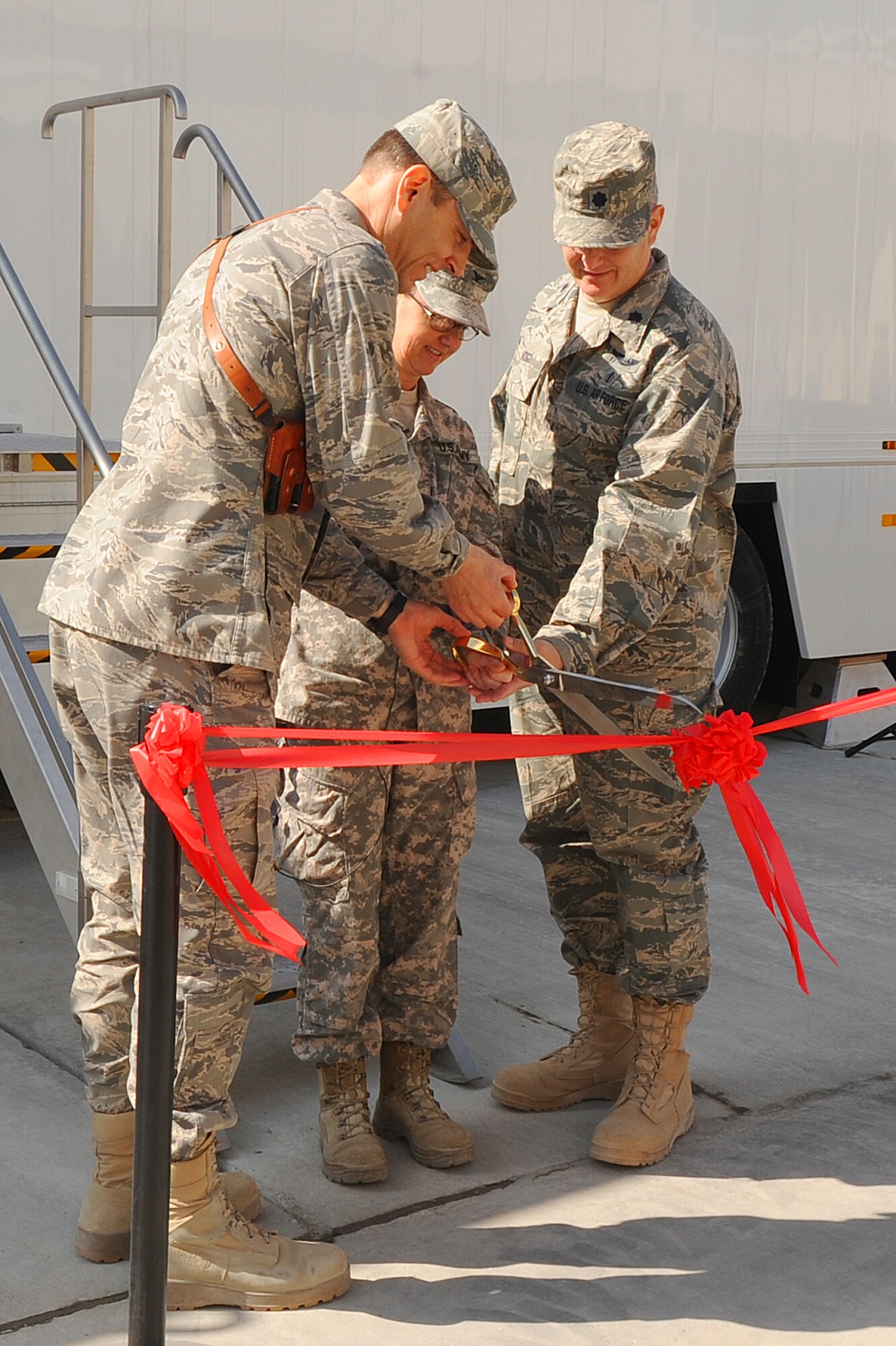 Col. James Sperl, 455th Expeditionary Medical Group deputy commander, COL. Jane Prather, Task Force Medical East deputy commander, and Lt. Col. Charles Voigt, 455 EMDG radiology flight commander cut the ribbon for the grand opening of the new Magnetic Resonance Imagine machine at Craig Joint Theater Hospital Oct. 24, 2011. This MRI was one of three implemented throughout the AOR.   The MRI will provide another diagnostic tool to aide physicians treating traumatic brain injury.
(U.S. Air Force photo/Senior Airman Krista Rose)