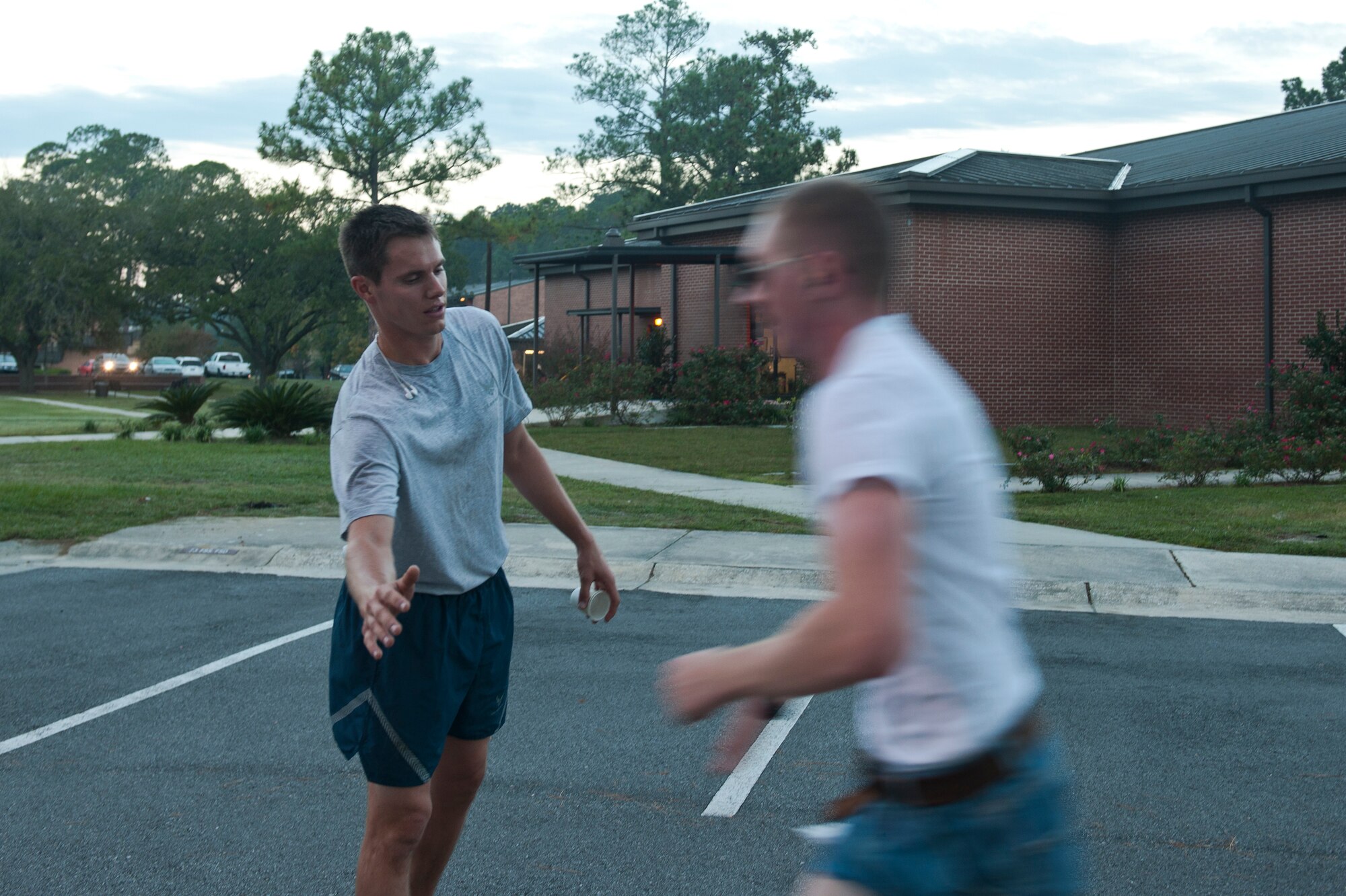 U.S. Air Force Senior Airman Sean Conaway, 23rd Civil Engineer Squadron engineer assistant, reaches out to slap hands with an Airman approaching the finish line during the Scary Pumpkin 5K run at Moody Air Force Base, Ga., Oct. 28, 2011. Conaway finished the run first and cheered on other Airmen with words of encouragement. (U.S. Air Force photo by Airman 1st Class Joshua Green/Released)             
         
