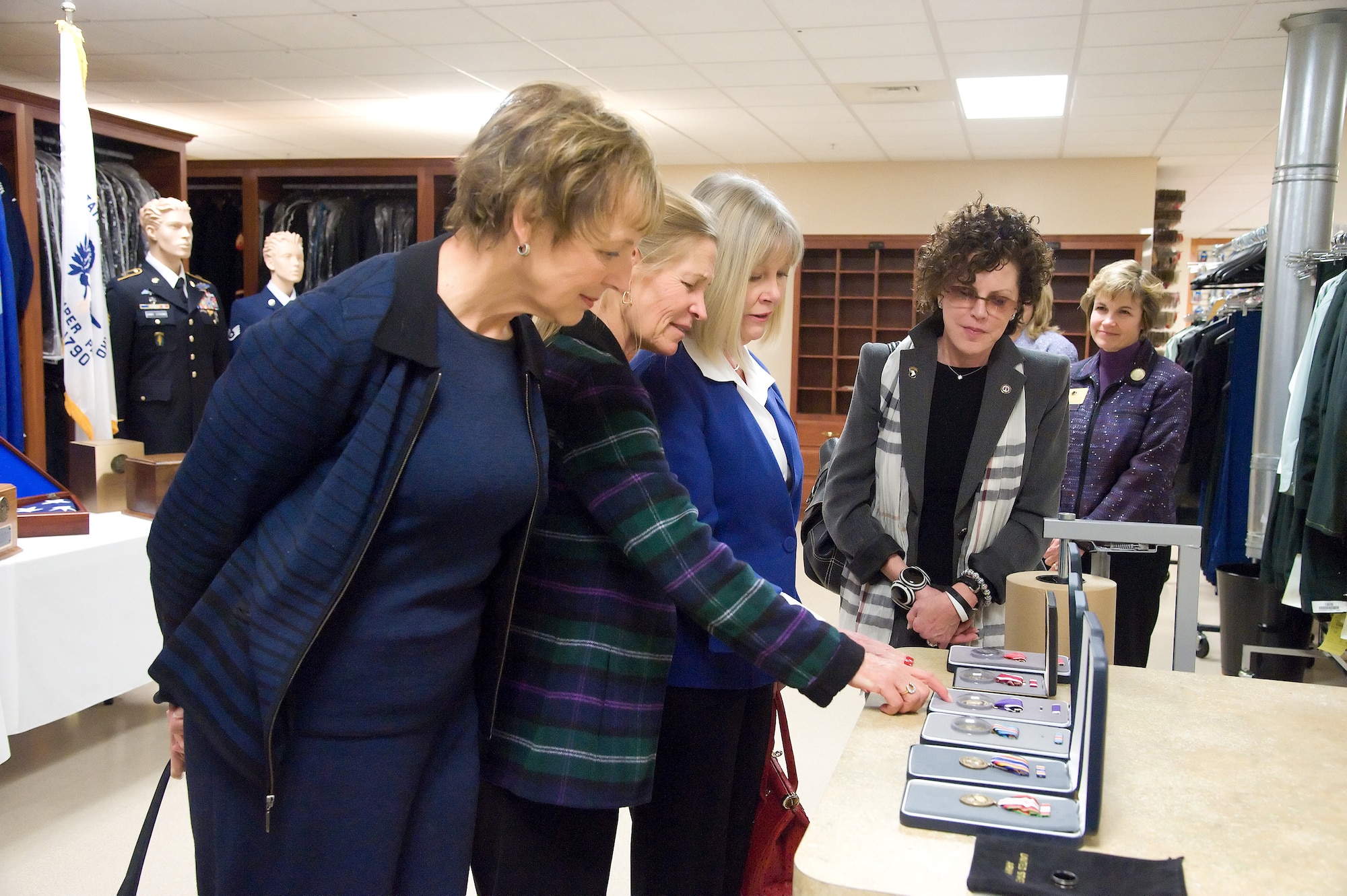 Mary Jo Myers, Fisher House trustee, Audrey Fisher, Board of Trustee Vice Chairmen, Suzie Schwartz, wife of Chief of Staff of the Air Force Gen. Norton A. Schwartz and Nancy Edelman, Board of Trustee Vice Chairmen, look at medal sets given to families of fallen service members during a visit to the Charles C. Carson Center for Mortuary Affairs Oct. 28, 2011.  (U.S. Air Force photo/Adrian R. Rowan)