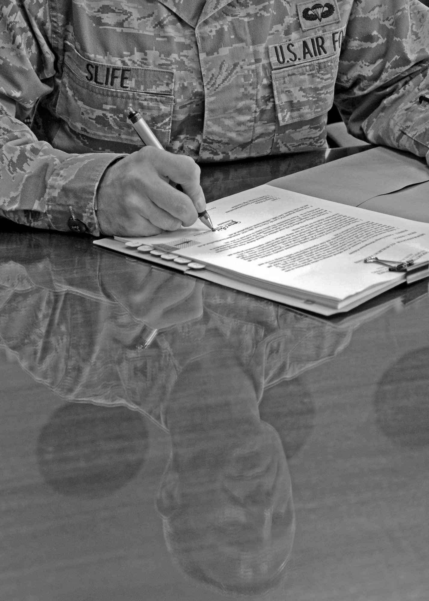 U.S. Air Force Col. Jim Slife, commander of the 1st Special Operations Wing, signs the official facility energy management policy letter for Hurlburt Field, Fla., Oct 26, 2011. The policy defines Hurlburt Fields role in energy conservation by providing guidelines on how facility energy is to be used and managed. (U.S. Air Force photo illustration/Staff Sgt. William Banton)(Released) 