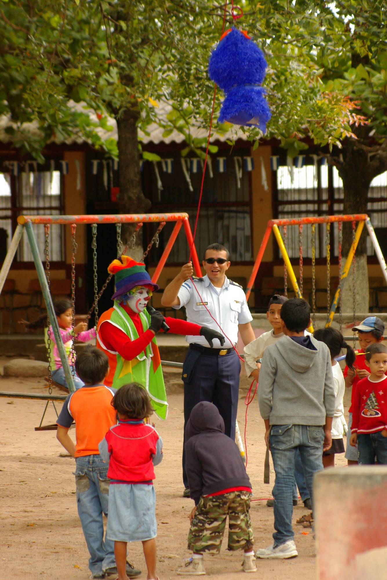 A clown and a Honduran aviator interact with the children during the piñata contest in Villa de San Antonio at the Honduran Air Force’s health fair Oct. 22. The 612th Air Base Squadron, Soto Cano Air Base, Honduras, donated 10 piñatas to support the medical outreach. More than 350 children attended the health fair. The Honduran Air Force’s medical brigade personnel established 25 clinics, which included pediatric, oncology, gynecology, dental and general medical assistance. The medical professionals treated 2,710 patients. The Honduran Aviation Military Academy will conduct the next health fair in the municipality of Meambar in November. (U.S. Air Force photo/Lt. Col. Lloyd Malone)