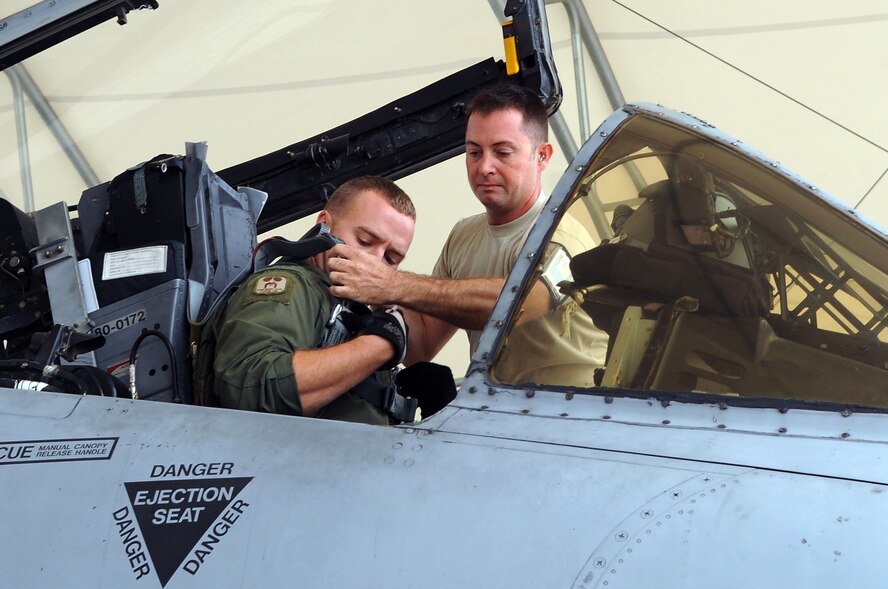 U.S. Air Force Staff Sgt. Michael Mimdziak, 476 Maintenance Squadron crew chief, prepares Capt. Samuel Chipman, 23rd Operation Support Squadron pilot for takeoff at Moody Air Force Base, Ga., Oct. 27, 2011. Crew chiefs maintain the aircraft to ensure proper function before, during and after flight. Without their expertise, pilots wouldn’t have functioning equipment while conducting missions. (U.S. Air Force photo by Airman 1st Class Olivia Dominique/Released)