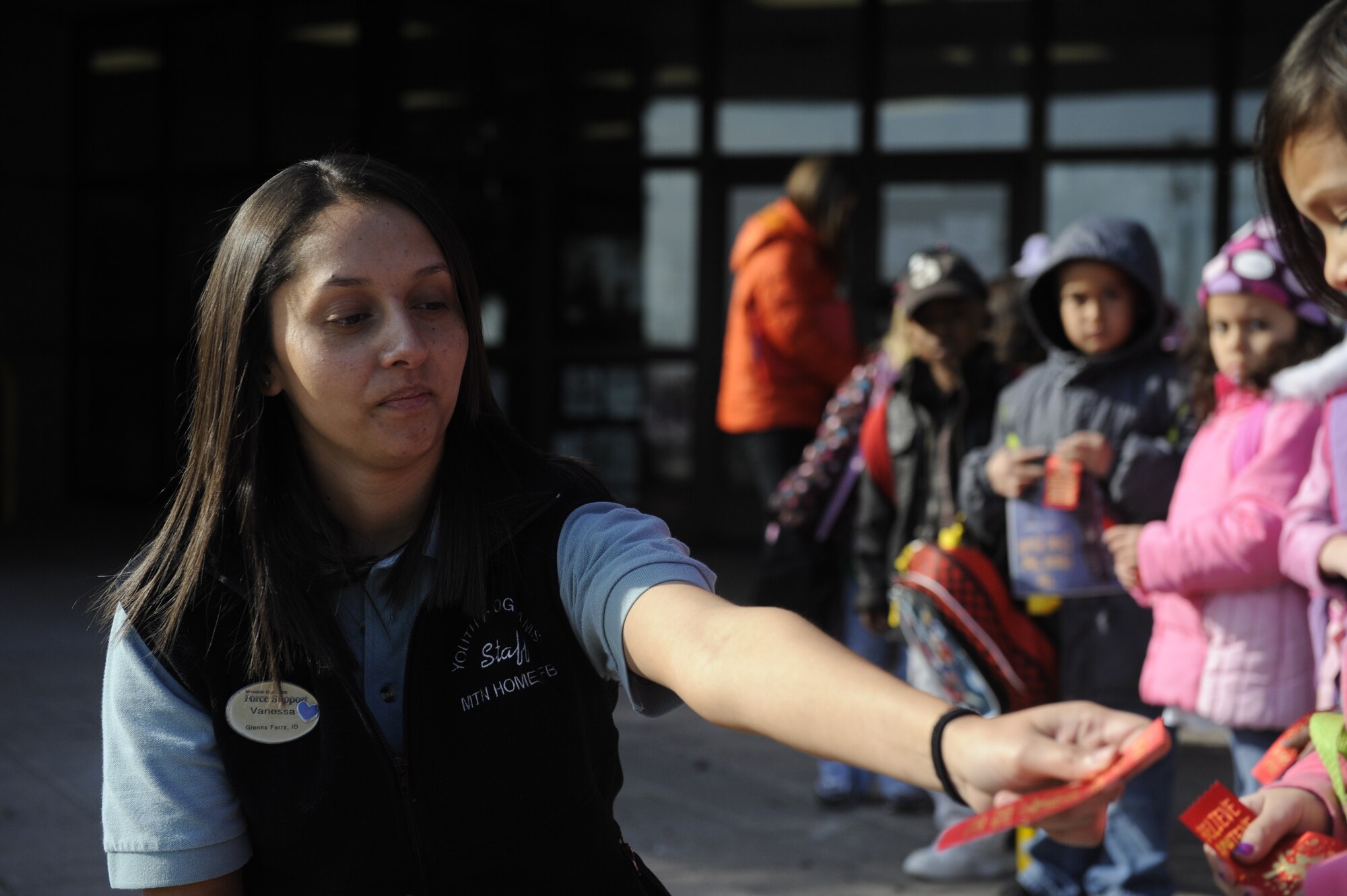Vanessa Gil, youth program assistant hands out red ribbons in commemoration of Red Ribbon Week Oct. 27, 2011, at Mountain Home Air Force Base, Idaho. The ribbons symbolize unity in the fight against drugs. (U.S. Air Force photo by Airman Shane M. Phipps)