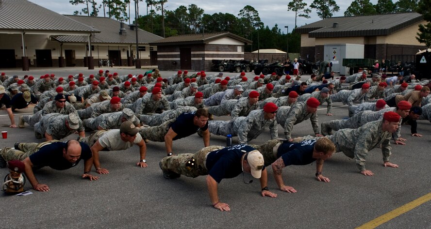 U.S. Air Force Airmen participate in memorial pushups during the Tim Davis Memorial March ceremony held at the Special Tactics Training Squadron pavilion on Hurlburt Field, Fla., Oct. 26, 2011. Memorial push-ups are performed to commemorate those who have fallen in combat. (U.S. Air Force photo/Airman 1st Class Christopher Williams)(Released)
