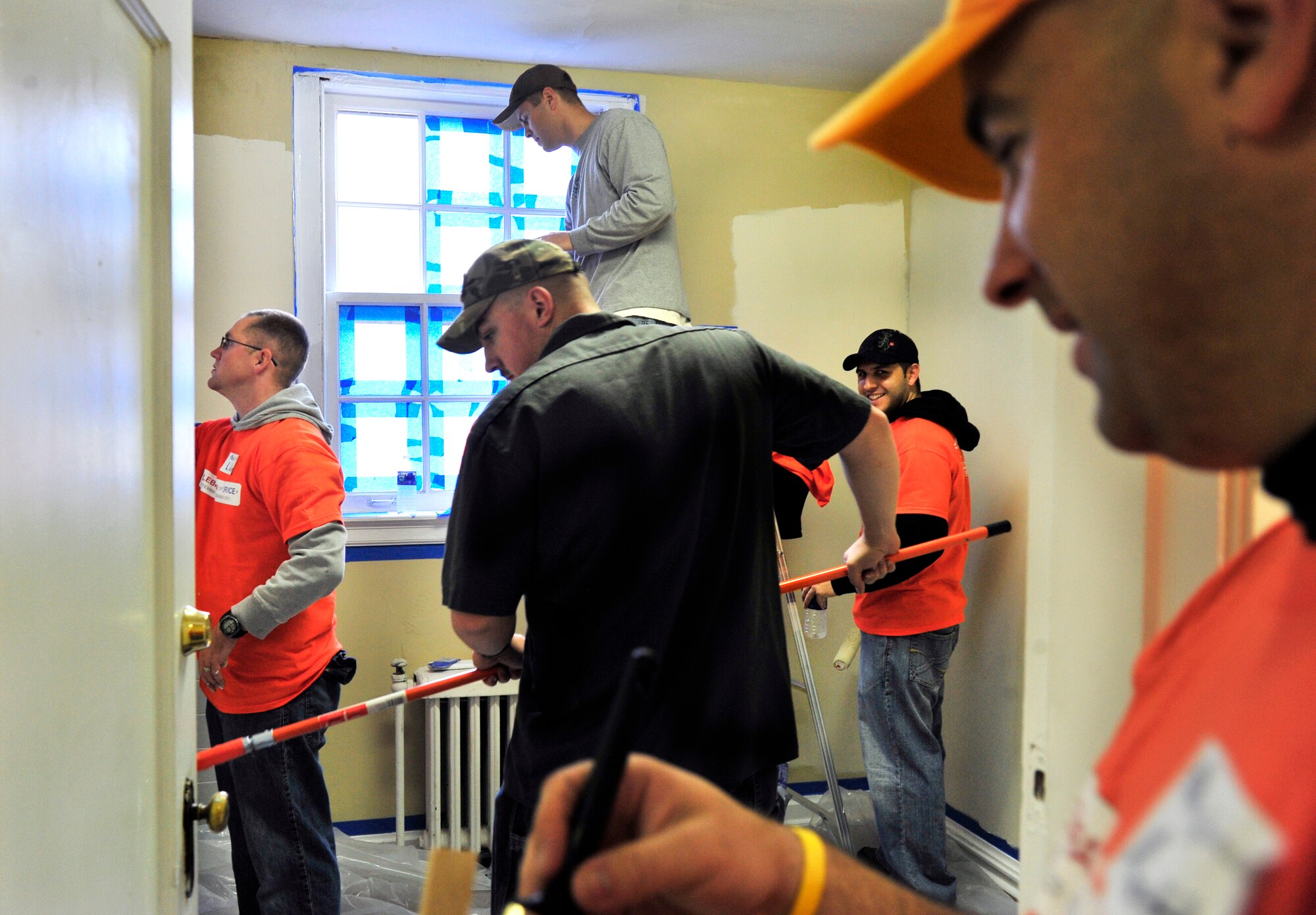 Members assigned to Scott Air Force Base paint an entire room from top to bottom in a donated house Oct. 27 during the Celebration of Service campaign event in Saint Louis, Mo. More than 350 volunteers rehabilitated a donated church building into a technology training and resource center for veterans allowing them a place to transition from military into civilian life.  The new facility will provide veterans with instruction and skills training to preparing them for employment The campaign launched by Home Depot and the Mission Continues, was created to enhance the lives of U.S. military veterans and to highlight the needs and opportunities they face. (U.S. Air Force photo/ Staff Sgt. Stephenie Wade)
