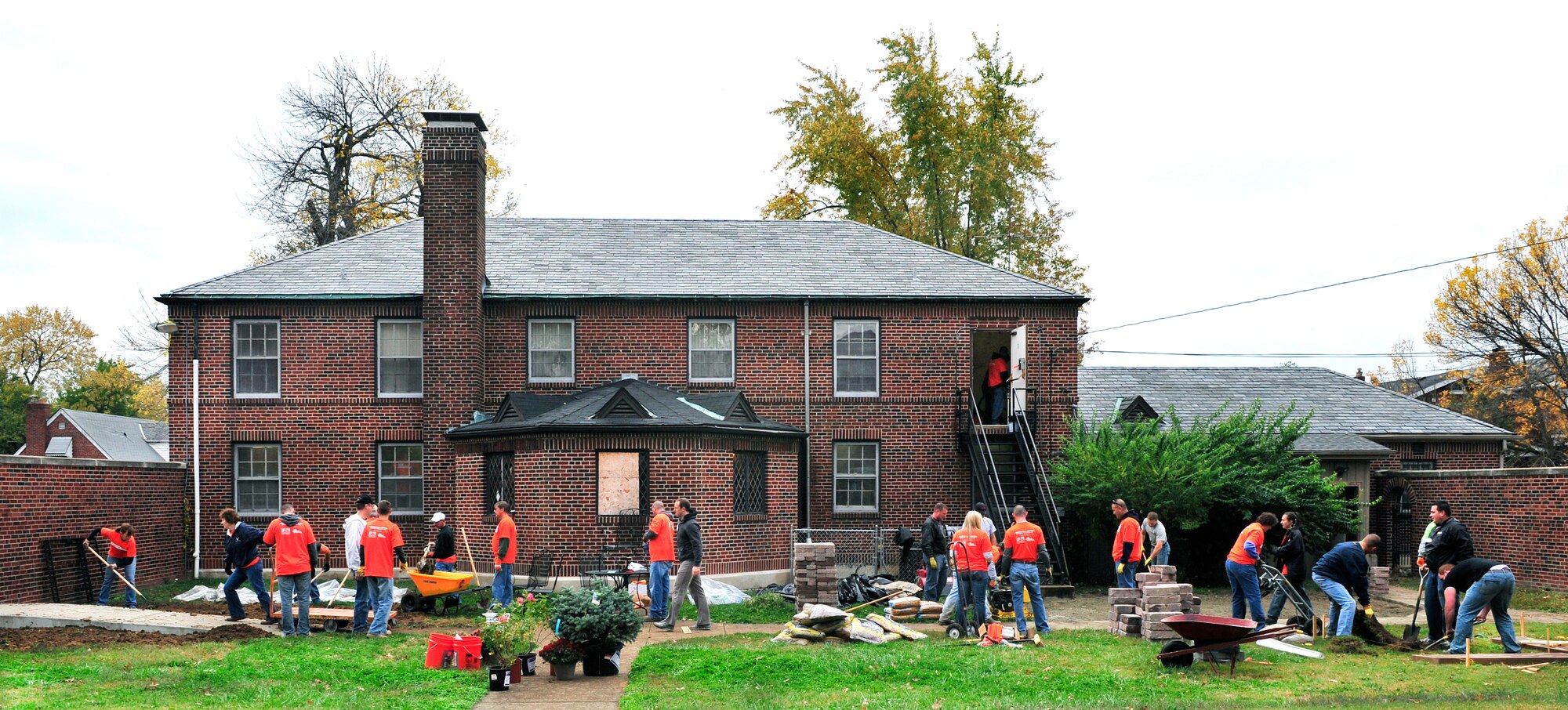 Scott Air Force base and community volunteers construct a patio area and new landscaping in the back yard of a donated house Oct 27 during the Celebration of Service campaign event in Saint Louis, Mo. The volunteers rehabilitated a donated church building into a technology training and resource center for veterans allowing them a place to transition from military into civilian life.  The new facility will provide veterans with instruction and skills training to preparing them for employment The campaign launched by Home Depot and the Mission Continues, was created to enhance the lives of U.S. military veterans and to highlight the needs and opportunities they face.  (U.S. Air Force photo/ Staff Sgt. Stephenie Wade)