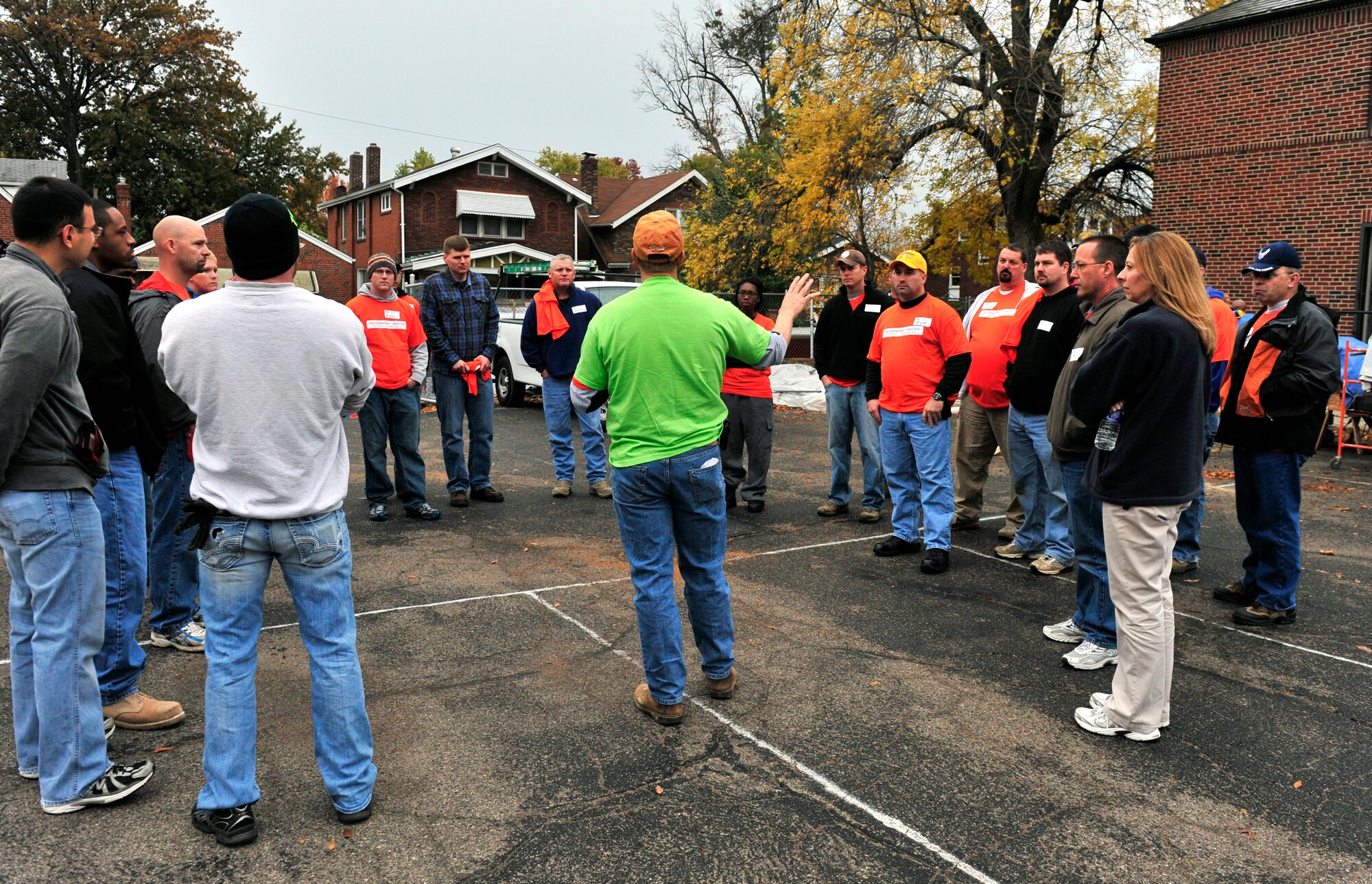 Team Scott and community  volunteers receive instructions from their group leader Oct. 27 during the Celebration of Service campaign event in Saint Louis, Mo. The volunteers rehabilitated a donated church building into a technology training and resource center for veterans allowing them a place to transition from military into civilian life.  The new facility will provide veterans with instruction and skills training to preparing them for employment The campaign launched by Home Depot and the Mission Continues, was created to enhance the lives of U.S. military veterans and to highlight the needs and opportunities they face.  (U.S. Air Force photo/ Staff Sgt. Stephenie Wade)