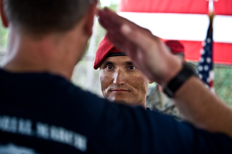 U.S. Air Force airman salutes during the Tim Davis Memorial March ceremony at the Special Tactics Training Squadron pavilion on Hurlburt Field, Fla., Oct. 26, 2011. During the ceremony the airmen that participated in the march hand off batons engraved with the names of their fallen comrades honoring the 17 airmen that have given their lives since Oct. 2010.

