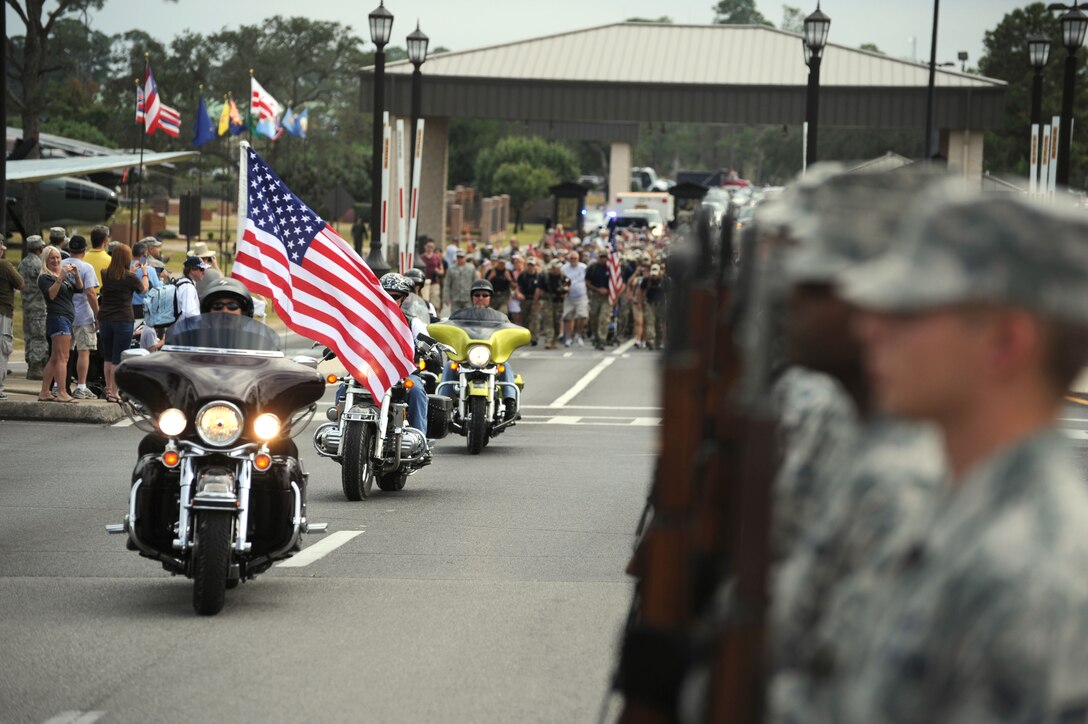 Members of the Hurlburt Field motorcycle group, Sentinels of Freedom, led 18 Special Tactics Airmen, family and co-workers, through the main gate as they complete an 812-mile memorial march from Lackland Air Force Base, Texas, to Hurlburt Field, Fla. Special Tactics Airmen perform this march each year that a Special Tactics Airman loses his life in defense of his country. (U.S. Air Force photo/Master Sgt. Steven Pearsall) (RELEASED)