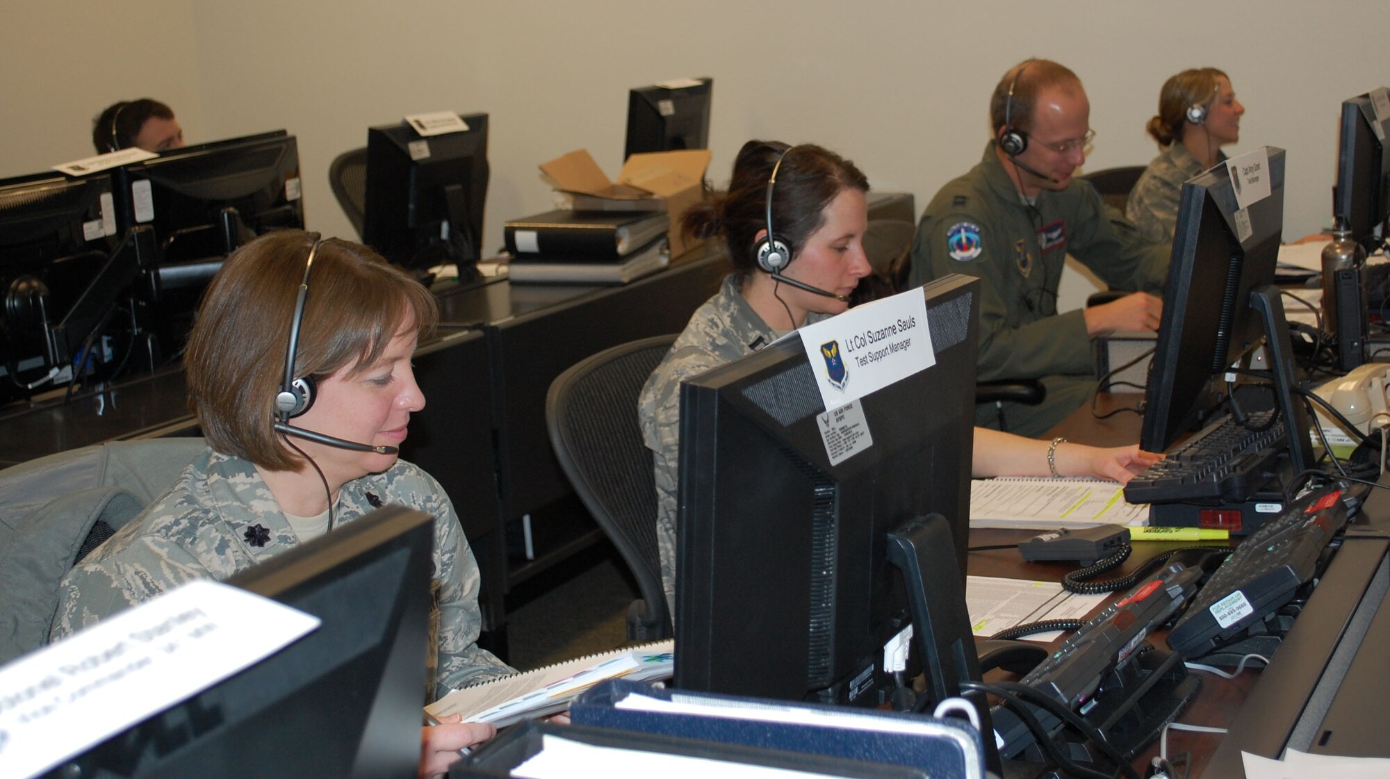 Personnel from Malmstrom Air Force Base along with a team from the 576th Intercontinental Ballistic Missile Flight Test Squadron from Vandenberg AFB, Calif., conducted a Simulated, Electronic, Launch of a Minuteman, or SELM test Oct. 18-20. Lt. Col. Suzanne Sauls, 341st Missile Maintenance Squadron commander (left) was the support manager for the test. Also pictured are Capt. Amy Grant, test manager; Capt Adrian Zollinger, test conductor; and 1st Lt. Suzie Thiele, weapons system advisor. They were concuting pre-test communications checks prior to the actual SELM. (U.S. Air Force photo/Valerie Mullett)