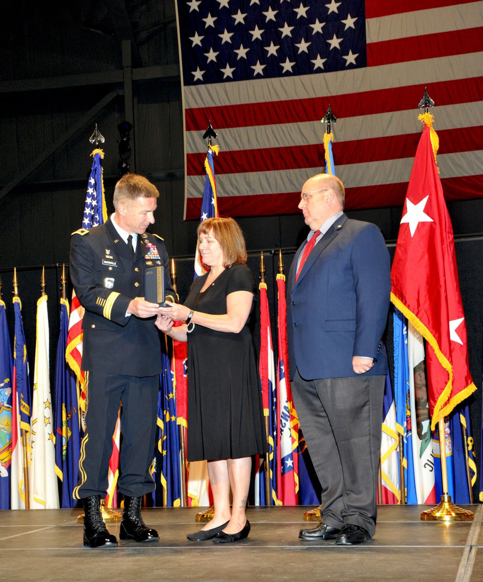 DAYTON, Ohio -- Army Major General James C. McConville, Commanding General, 101st Airborne Division (Air Assault) based in Fort Campbell, Ky., presented the Award of the Silver Star posthumously to Army Specialist Jesse Adam Snow during a ceremony at the National Museum of the U.S. Air Force. Snow's parents, Air Force Chief Master Sgt. (Ret.) John W. Snow Sr. and his wife Janice, accepted the award on Jesse's behalf. (U.S. Air Force Photo)