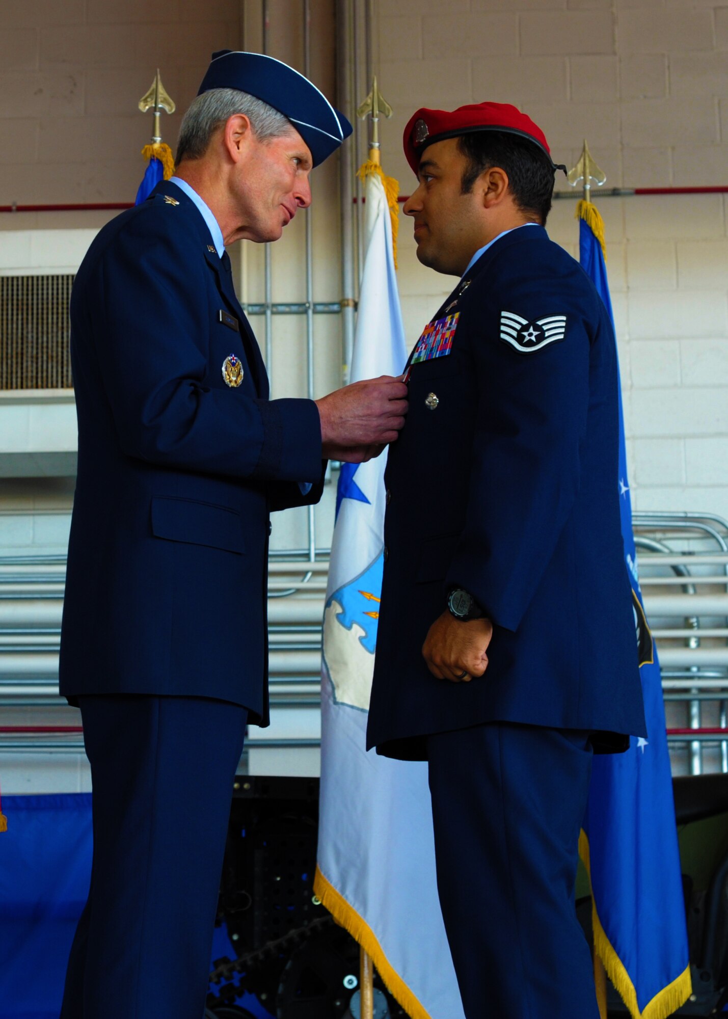 Air Force Chief of Staff Gen. Norton Schwartz presents the Air Force Cross to Staff Sgt. Robert Gutierrez, Special Tactics and Training Squadron combat controller, during a ceremony at Hurlburt Field, Fla., Oct. 27, 2011. Gutierrez was awarded the Air Force Cross, the second highest military decoration, for displaying extraordinary heroism in combat while deployed in support of Operation Enduring Freedom. (U.S. Air Force photo/Staff Sgt. Sharida Jackson)