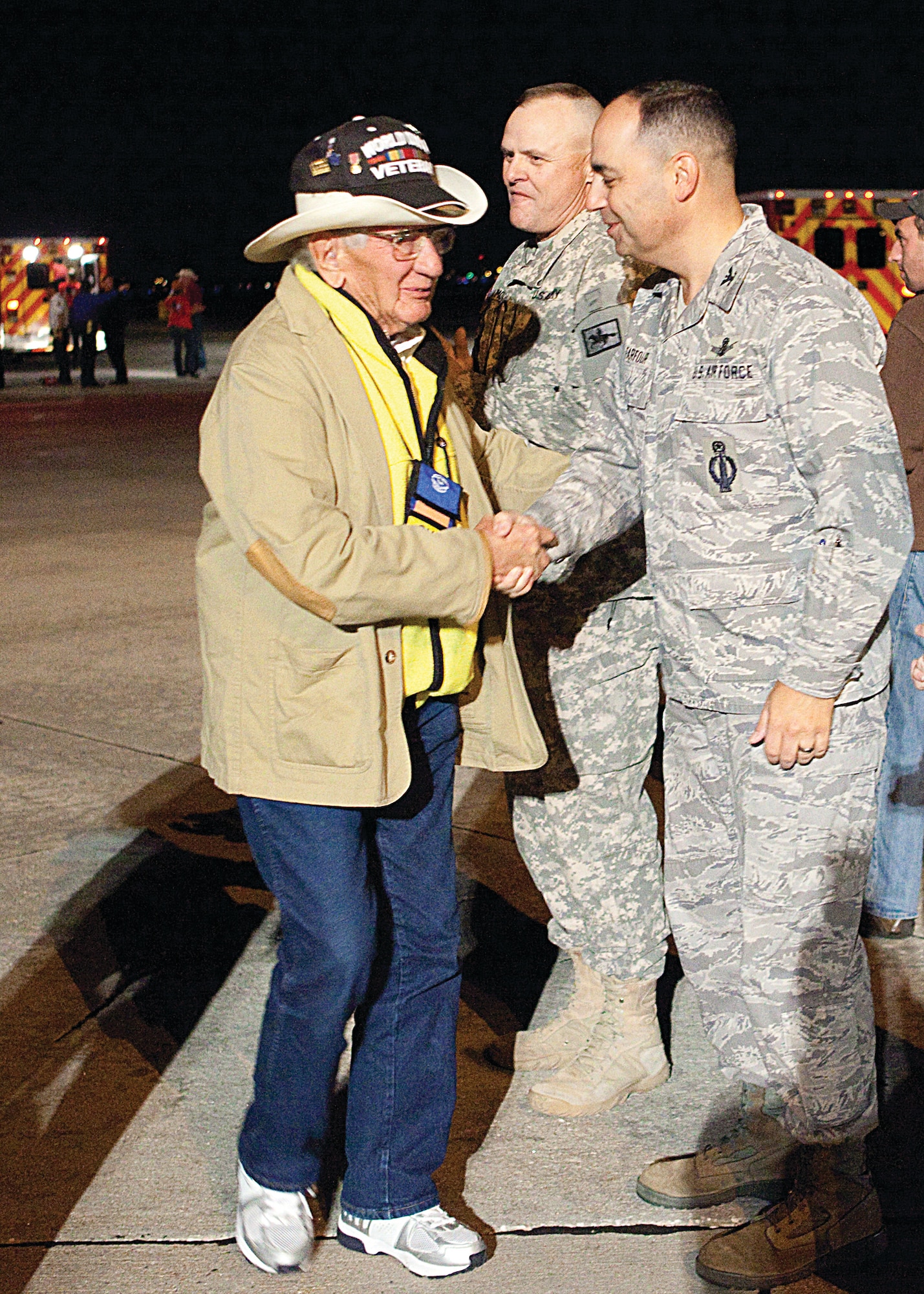 Col. George Farfour, 90th Missile Wing vice commander, greets a returning World War II veteran at the Cheyenne Regional Airport Oct. 12. The veteran was one of many who took part in the final Honor Flight. (U.S. Air Force photo by Matt Bilden)