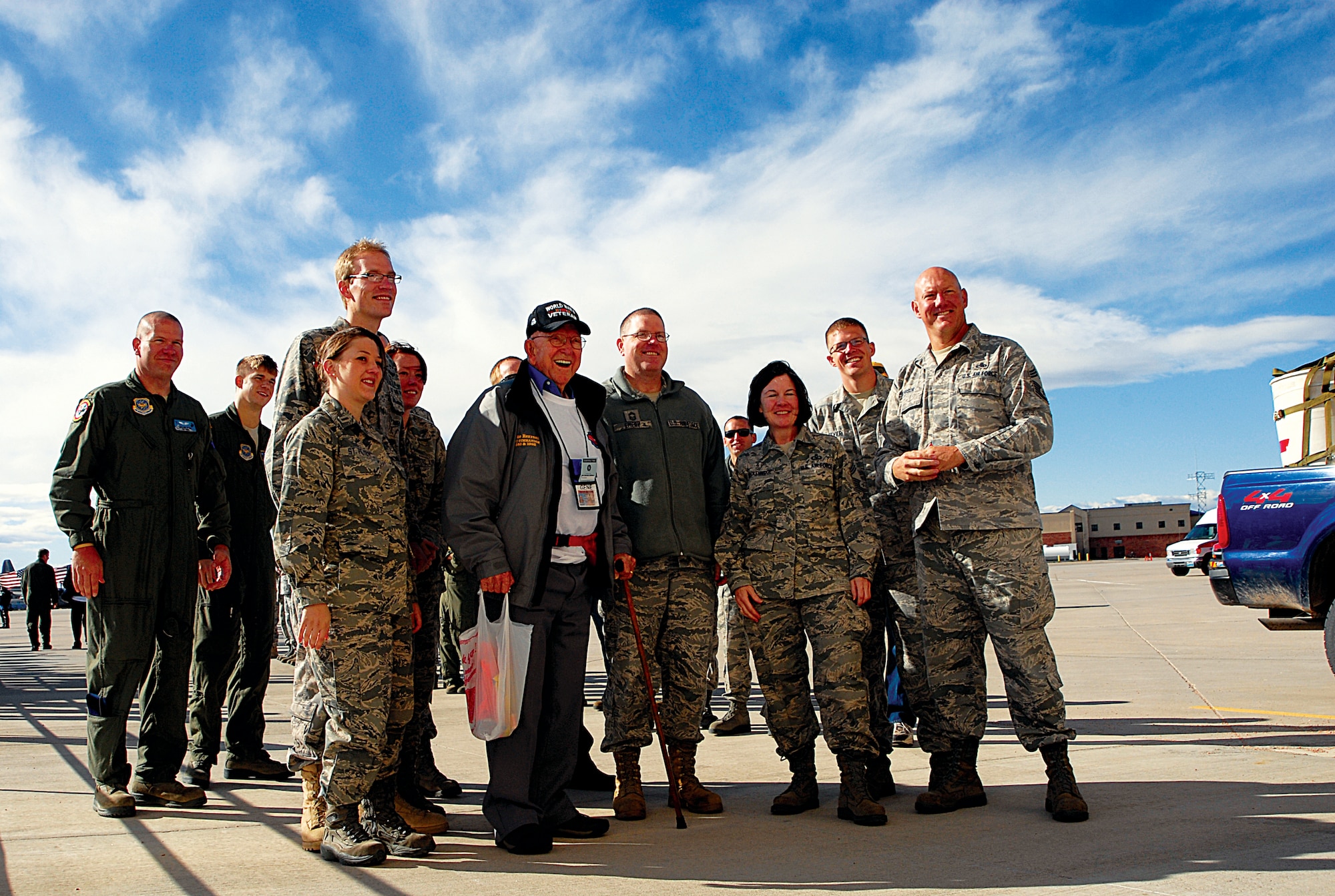 Members from the Wyoming National Guard pose for a photograph with a World War II veteran prior to the veteran boarding a plane at the Cheyenne Regional Airport Oct. 11. (U.S. Air Force photo by Staff Sgt. Natalie Stanley)