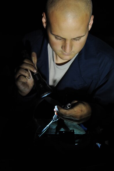 Airman 1st Class Elson Tracey searches for a ratchet wrench during a rudder repair on Seymour Johnson Air Force Base, N.C., Oct. 25, 2011. 4th Aircraft Maintenance Squadron (AMXS) Airmen work around the clock to support the flight mission. Tracey is a 4 AMXS crew chief and hails from Noblesville, Ind.  (U.S. Air Force photo by Senior Airman Whitney Stanfield)
