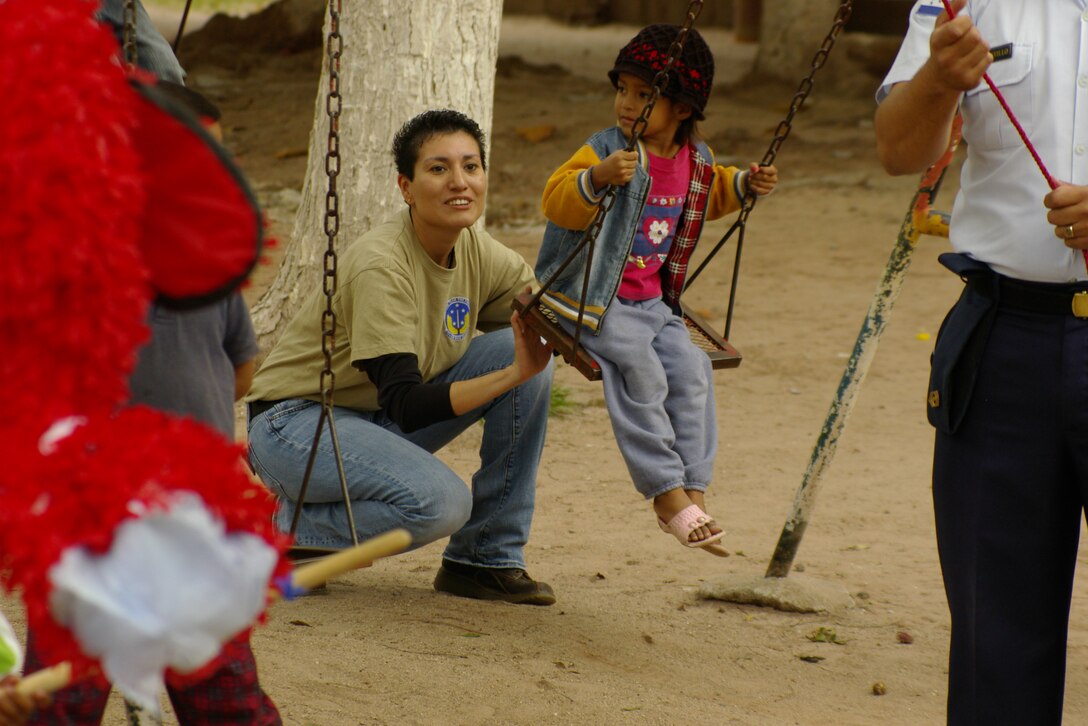 Tech. Sgt. Martha Ault, a Joint Task Force-Bravo member, gives a little girl a push on the swing set during the Honduran Air Force’s health fair Oct. 22 in Villa de San Antonio, Honduras. The 612th Air Base Squadron, Soto Cano Air Base, Honduras, donated 10 piñatas to support the medical outreach. More than 350 children attended the health fair.  The Honduran Air Force medical brigade personnel established 25 clinics, which included pediatric, oncology, gynecology, dental and general medical assistance.  The medical professionals treated 2,710 patients. The Honduran Aviation Military Academy will conduct the next health fair in the municipality of Meambar in November. (U.S. Air Force photo/Lt. Col. Lloyd Malone)