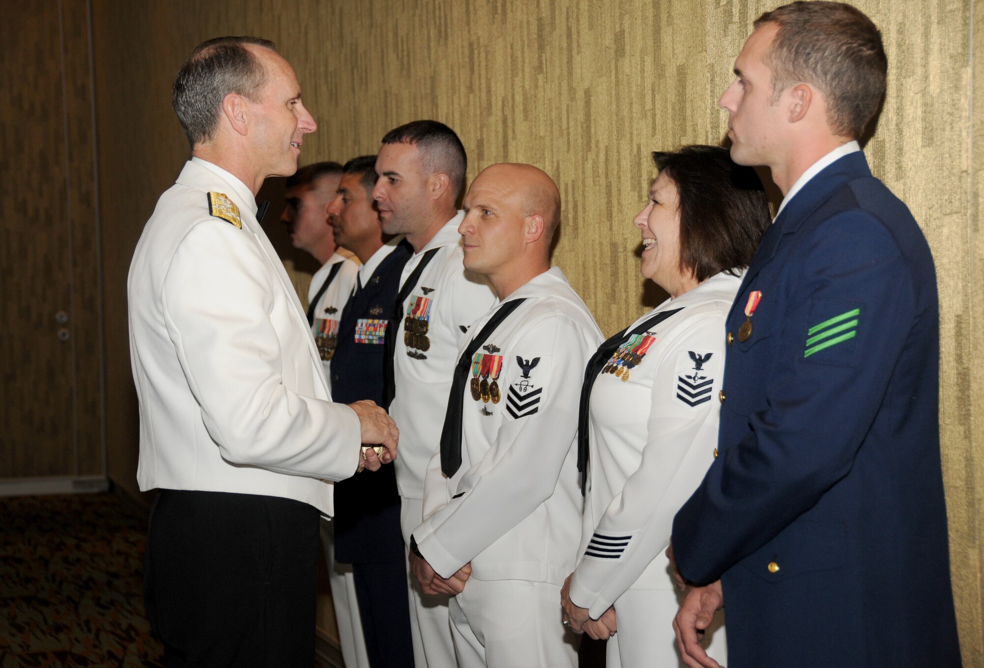 Left, Adm. Jonathan Greenert, Chief of Naval Operations, greets Petty Officer 1st Class Cynthia Burton, Center for Naval Aviation Technical Training Unit, Keesler Air Force Base, and other award nominees during the 33rd annual Salute to the Military, Oct. 25, 2011, at the Mississippi Coast Coliseum in Biloxi, Miss.  Greenert was the guest speaker for the event.  Every year at Salute to the Military, sponsored by the Mississippi Gulf Coast Chamber of Commerce, one local service member in grade E-6 or below is presented the Thomas V. Fredian Community Leadership Award.  The award honors professional performance and leadership, community involvement and education over the past year.  (U.S. Air Force photo by Kemberly Groue)
