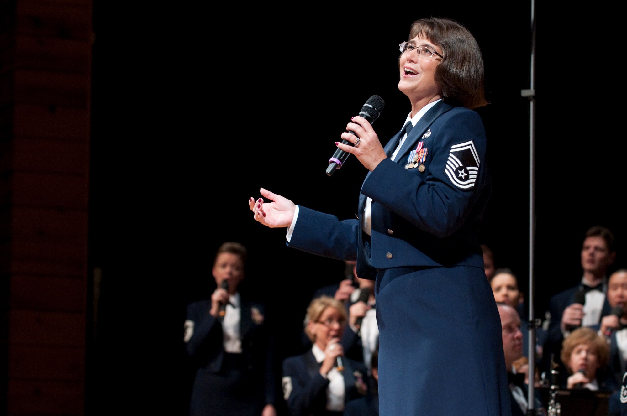 Senior Master Sgt. Robin McConnell, a member of the Singing Sergeants — the official chorus of the Air Force, performs a solo backed up by the rest of the chorus and the United States Air Force Concert Band during a concert in the Cheyenne Civic Center in Cheyenne, Wyo., Oct. 18. The Cheyenne performance, in front of an audience of 1400 people, was part of the band’s fall, western tour which includes stops in Montana, Wyoming, Nebraska and South Dakota. (U.S. Air Force photo by R.J. Oriez)