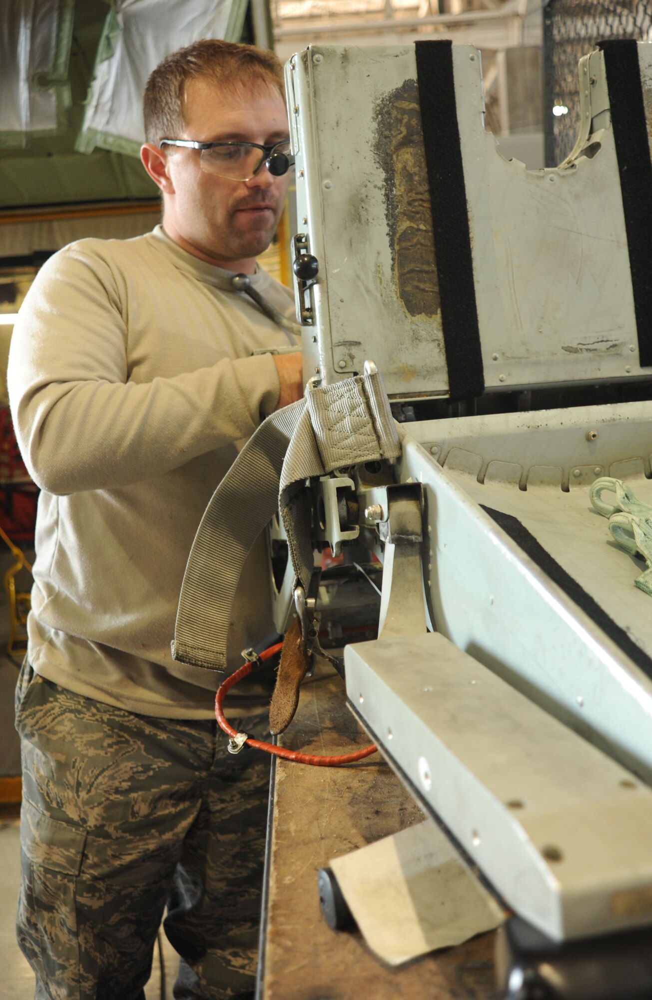 Staff Sgt. Brian Ross, 141st MXS full-time technician, repairs the pilot seat of a KC-135 at the Grant County International Airport Oct 18. Fairchild is the only base that takes all of the seats out before inspections. The 92nd and 141st Air Refueling Wings have been working side-by-side completing the mission in Moses Lake for almost a year now. (U.S. Air Force photo/Airman 1st Class Earlandez M. Young)