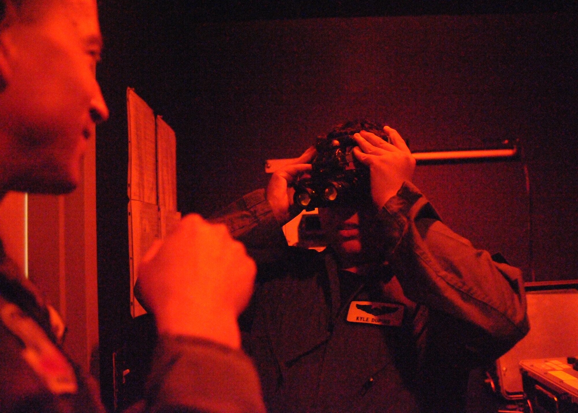 Kyle Dupuis uses infrared goggles to look at U.S. Air Force Lt. Col. Theodore Coiner, 357th Fighter Squadron assistant director of operations, in the 357th FS on Davis-Monthan Air Force Base, Ariz. Oct. 21, 2011. Coiner explained to Kyle that pilots sometimes use the goggles for night missions. (U.S. Air Force photo by Airman 1st Class Timothy D. Moore/Released)