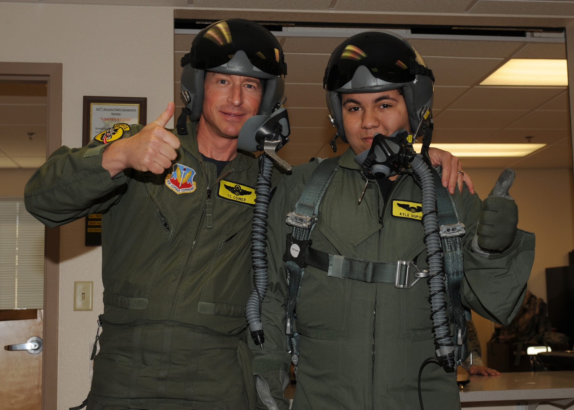 U.S. Air Force Lt. Col. Theodore Coiner, 357th Fighter Squadron assistant director of operations, poses with Kyle Dupuis in the 357th Fighter Squadron life support room on Davis-Monthan Air Force Base, Ariz. Oct. 21, 2011. Kyle was made an honorary pilot for the Pilot for a Day program. (U.S. Air Force photo by Airman 1st Class Timothy D. Moore/Released)