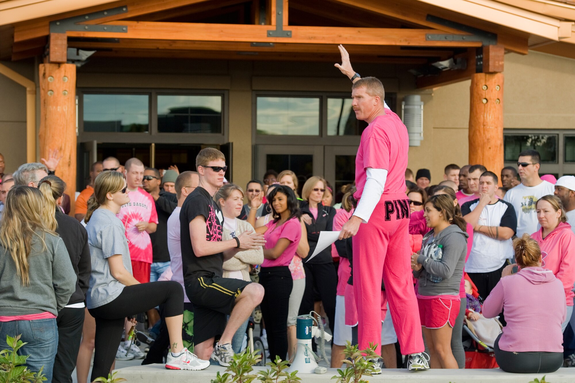 Kirk Clark, Health and Wellness Center exercise physiologist, announces instructions to the crowd of Team Malmstrom members participating in the 3-mile breast cancer awareness walk Oct. 21.