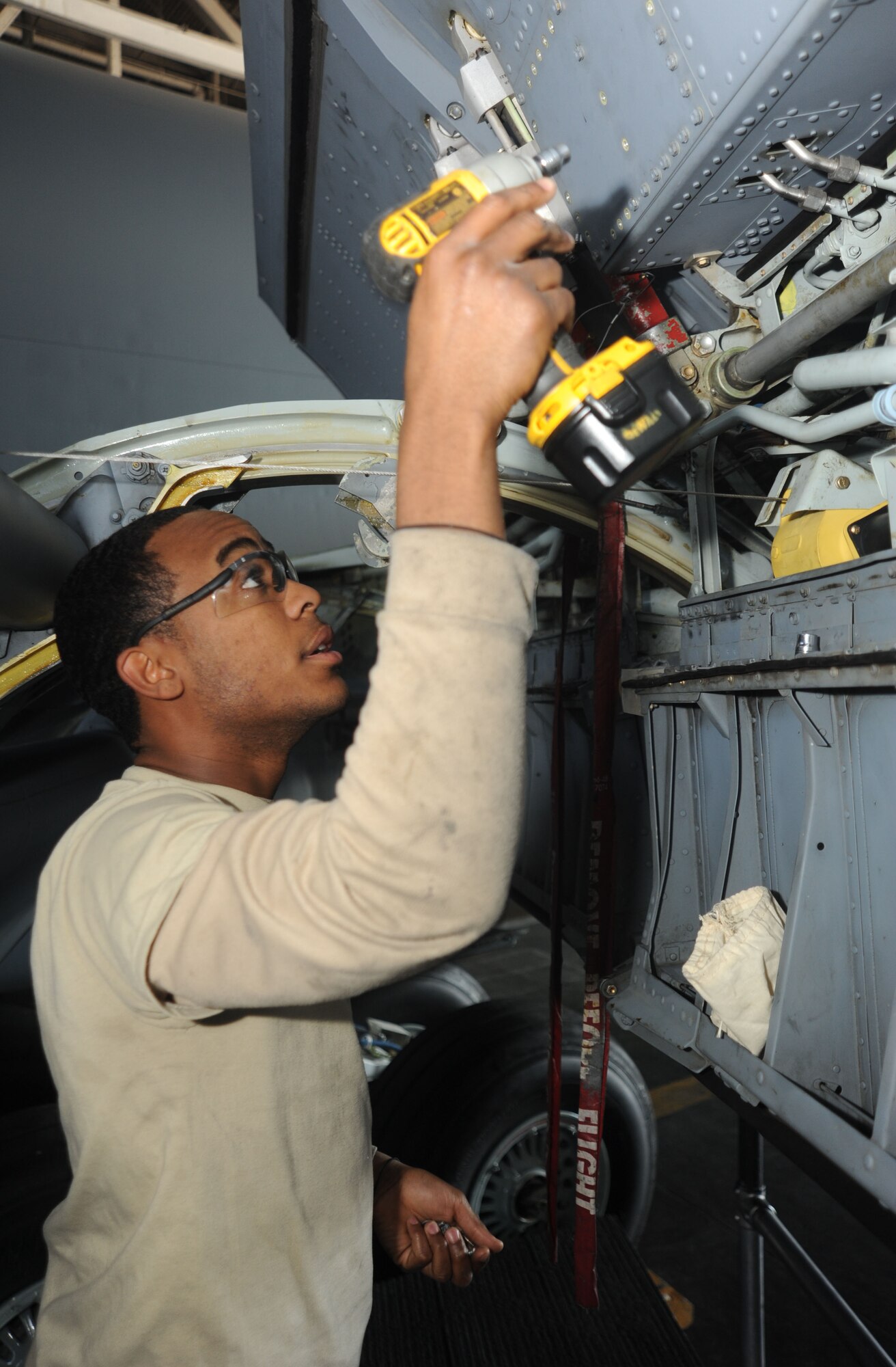 After taking off the wing panels of a KC-135, Airman 1st Class Vincent Williams, 92nd MXS crew chief, uses a power drill to put the panels back together at the Grant County International Airport Oct. 18. The panels have lots of small screws, which Williams had to carefully keep count of. If he loses even one screw, the wings can’t be operated until that screw is found and properly inserted.  (U.S. Air Force photo/Airman 1st Class Earlandez M. Young)