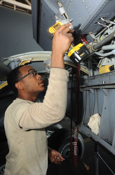 After taking off the wing panels of a KC-135, Airman 1st Class Vincent Williams, 92nd MXS crew chief, uses a power drill to put the panels back together at the Grant County International Airport Oct. 18. The panels have lots of small screws, which Williams had to carefully keep count of. If he loses even one screw, the wings can’t be operated until that screw is found and properly inserted.  (U.S. Air Force photo/Airman 1st Class Earlandez M. Young)