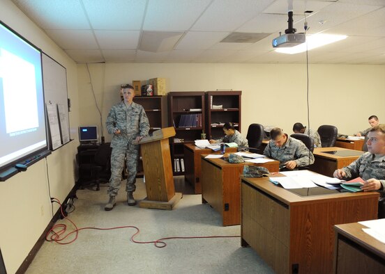 Staff Sgt. Kelby Mier, 7th Logistics Readiness Squadron, Hazmat Tech Specialist course instructor, goes through a presentation Oct. 27, 2011, at Dyess Air Force Base, Texas. The course is designed to give training and authorization to individuals to sign-off for hazardous materials. (U.S. Air Force photo by Airman 1st Class Cierra Bullock/Released)