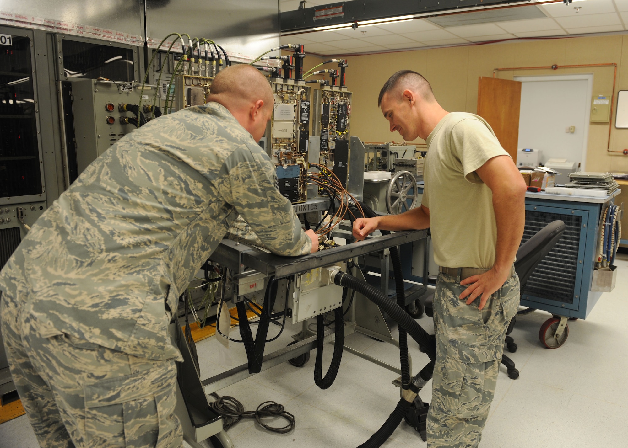 Tech. Sgt. Robert Nolen and Staff Sgt. Paul Ducote, 7th Component Maintenance Squadron, look at a band four receiver Oct. 27, 2011, at Dyess Air Force Base, Texas. 7 CMS provides a qualified work force to support the wing's global power and the 317th Airlift Group's global reach airlift missions. (U.S. Air Force photo by Airman 1ST Class Cierra Bullock)