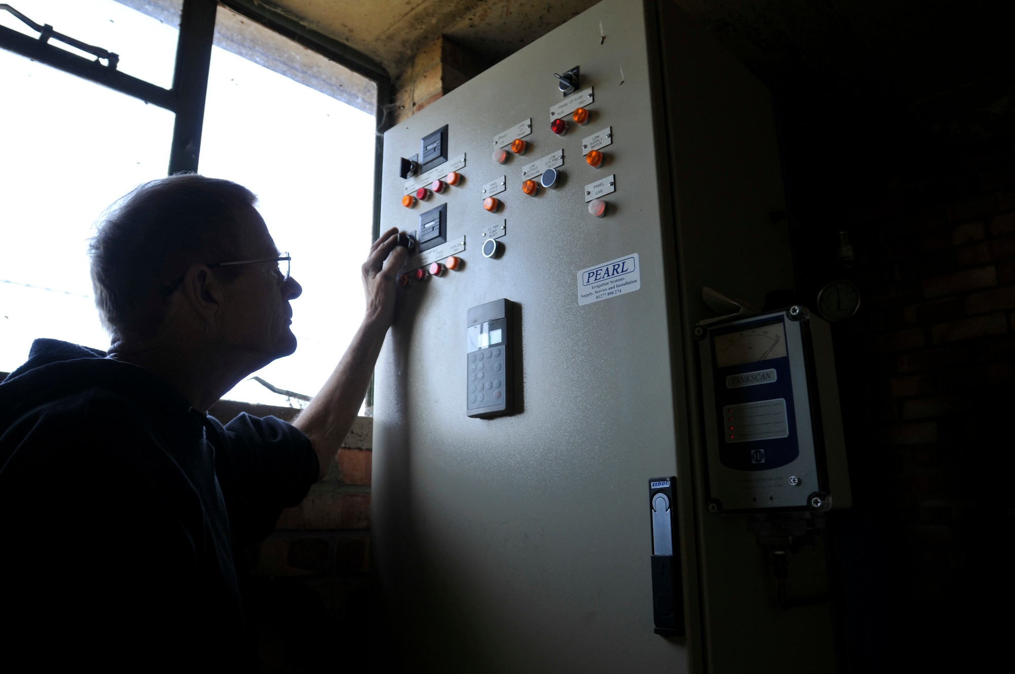 ROYAL AIR FORCE LAKENHEATH, England - Al Collier, 48th Force Support Squadron golf course superintendent, checks water flow rate gauges on the irrigation control panel at the Breckland Pines Golf Course Oct. 28, 2011.  In the 18 months since the golf course implemented initiatives to reduce water usage 10 million gallons have been saved, yielding a savings of $100,000.  (U.S. Air Force photo by Senior Airman Tiffany M. Deuel) 