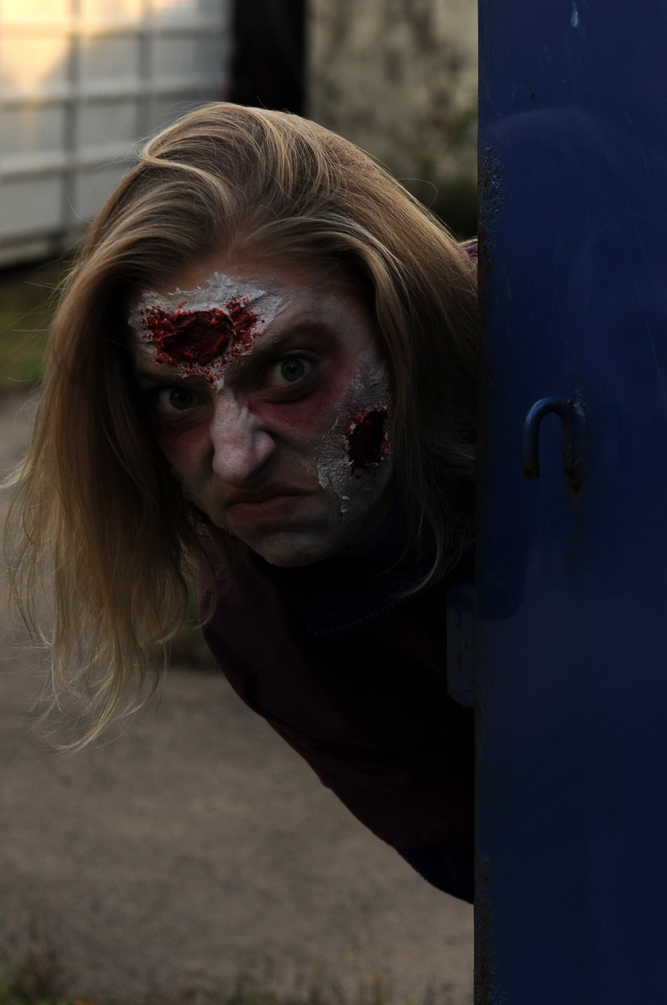 BITBURG ANNEX, Germany -- Capt. Jessica Isenberg, 52nd Dental Squadron dentist, hides behind a trash bin to scare attendees during a haunted house here Oct. 27. The haunted house is scheduled for Oct. 27-29 in Bldg. 2032 and 2033 at the French Casern on Bitburg Annex. Admission is $5 for adults and $3 for children younger than 13. The doors open at 5 p.m. every night. The first hour of the night is for younger children who just want to trick-or-treat. (U.S. Air Force photo/Airman 1st Class Brittney Frees)