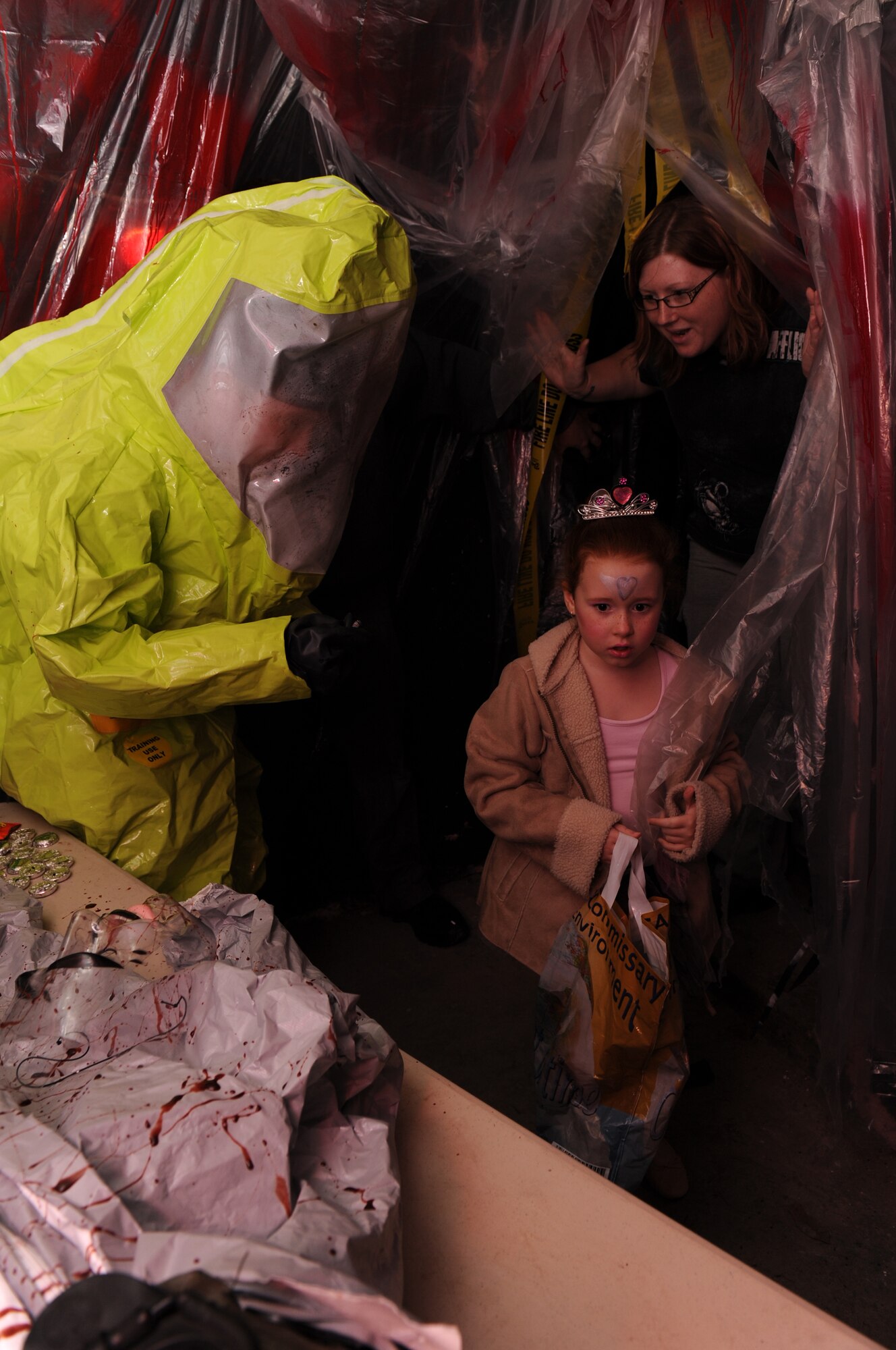 BITBURG ANNEX, Germany -- Sirenna Adams, daughter of Staff Sgt. Fred Adams, 52nd Civil Engineer Squadron structures craftsman, gets a scare as she walks through a haunted house here Oct. 27. The haunted house is scheduled for Oct. 27-29 in Bldg. 2032 and 2033 at the French Casern on Bitburg Annex. Admission is $5 for adults and $3 for children younger than 13. The doors open at 5 p.m. every night. The first hour of the night is for younger children who just want to trick-or-treat. (U.S. Air Force photo/Airman 1st Class Brittney Frees)